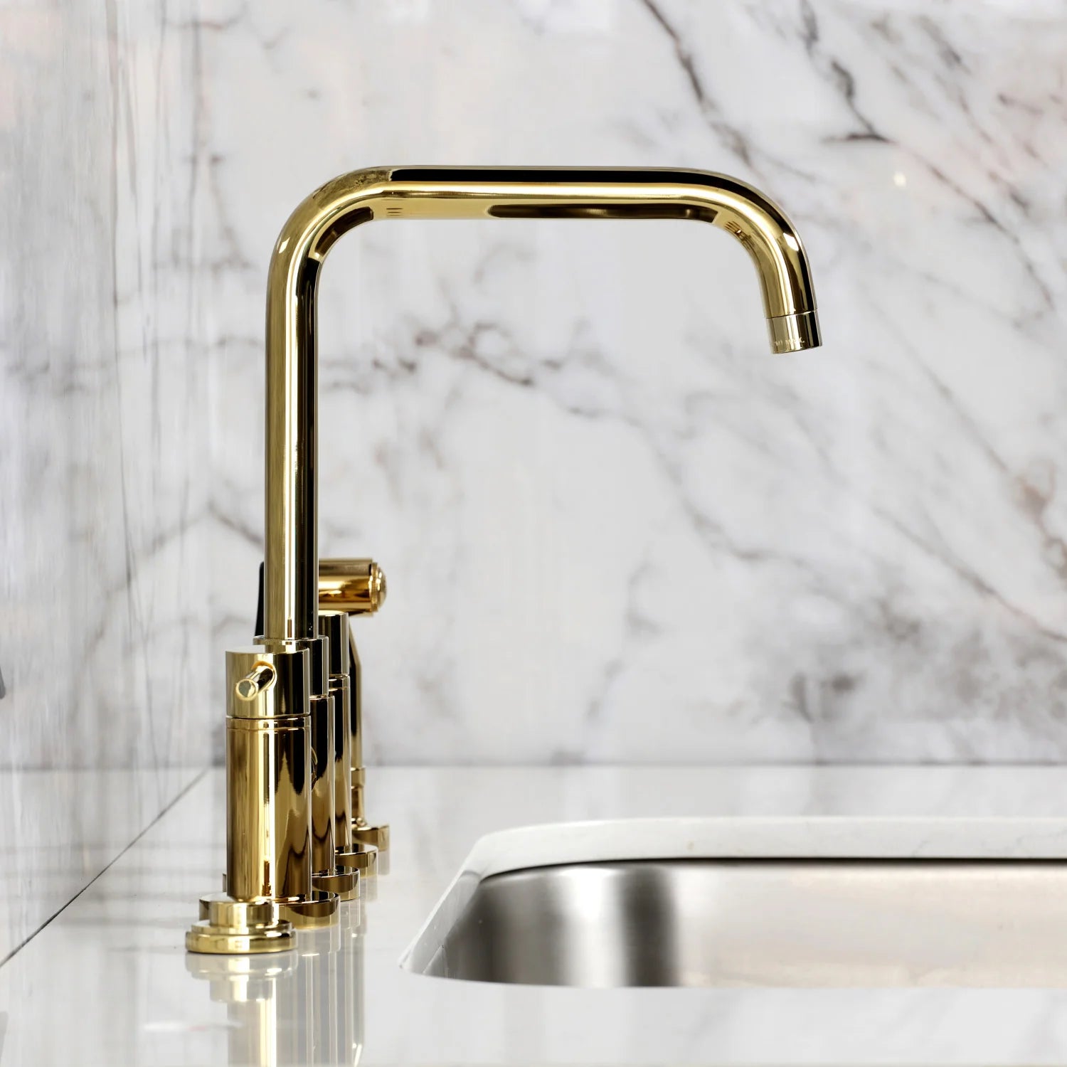 Polished brass tall gooseneck kitchen faucet with mounting base and lever handles