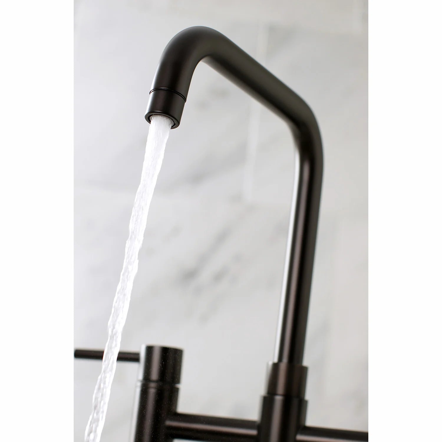 Oil-rubbed bronze kitchen faucet spout pouring water