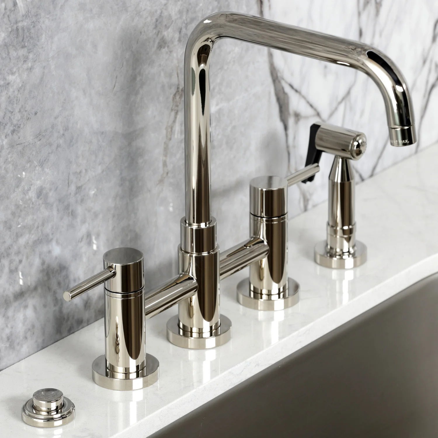Polished nickel deck-mounted kitchen faucet with curved spout, sprayer, and controls