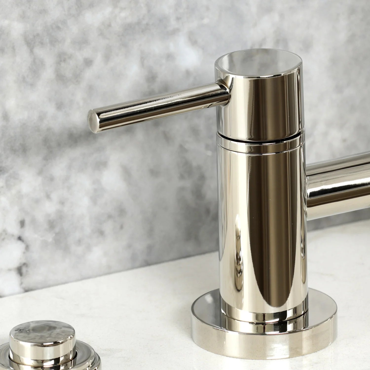 Polished nickel faucet with tall cylindrical spout and round handle control