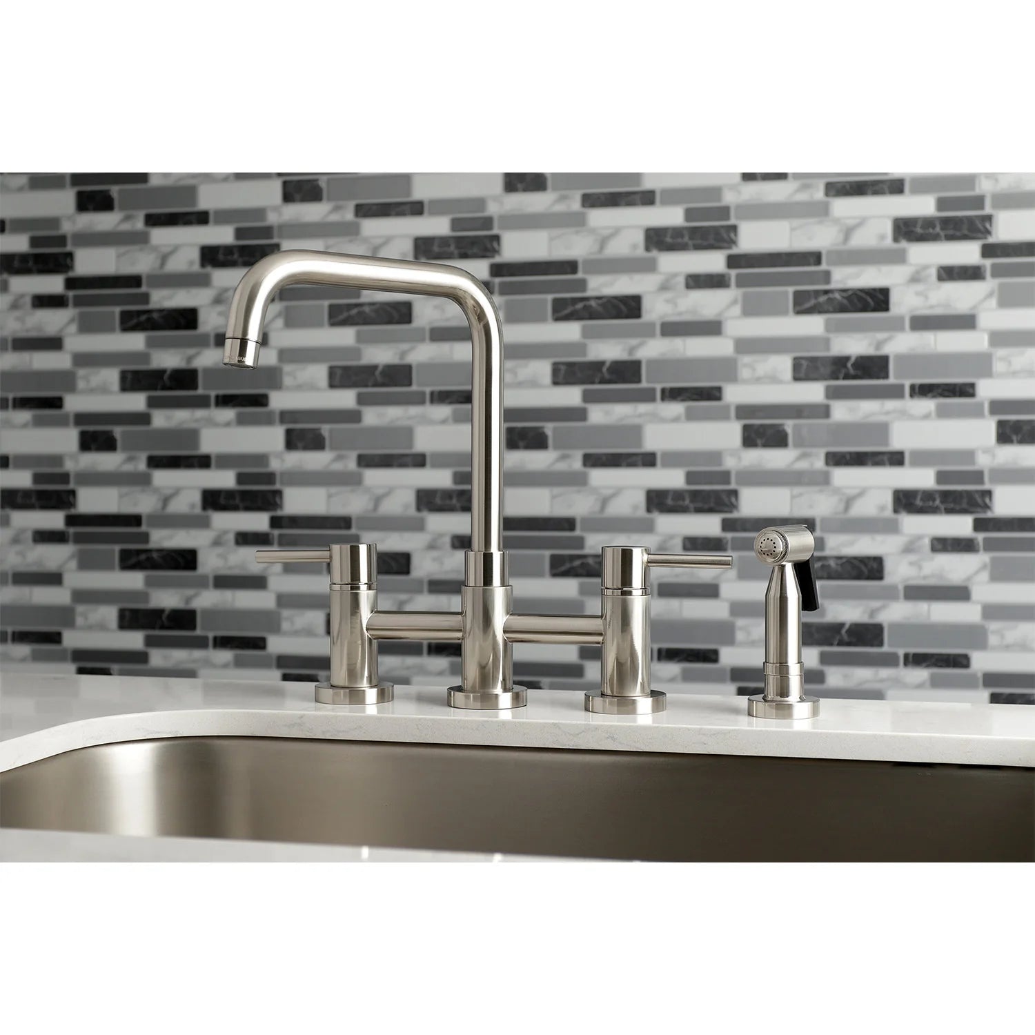 Brushed nickel bridge kitchen faucet with side sprayer and three handles