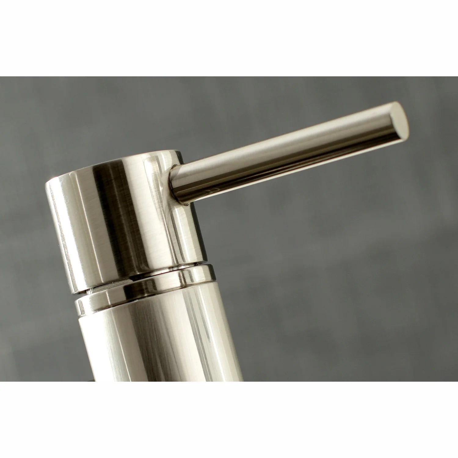 Brushed nickel faucet spout and handle base with smooth cylindrical cap