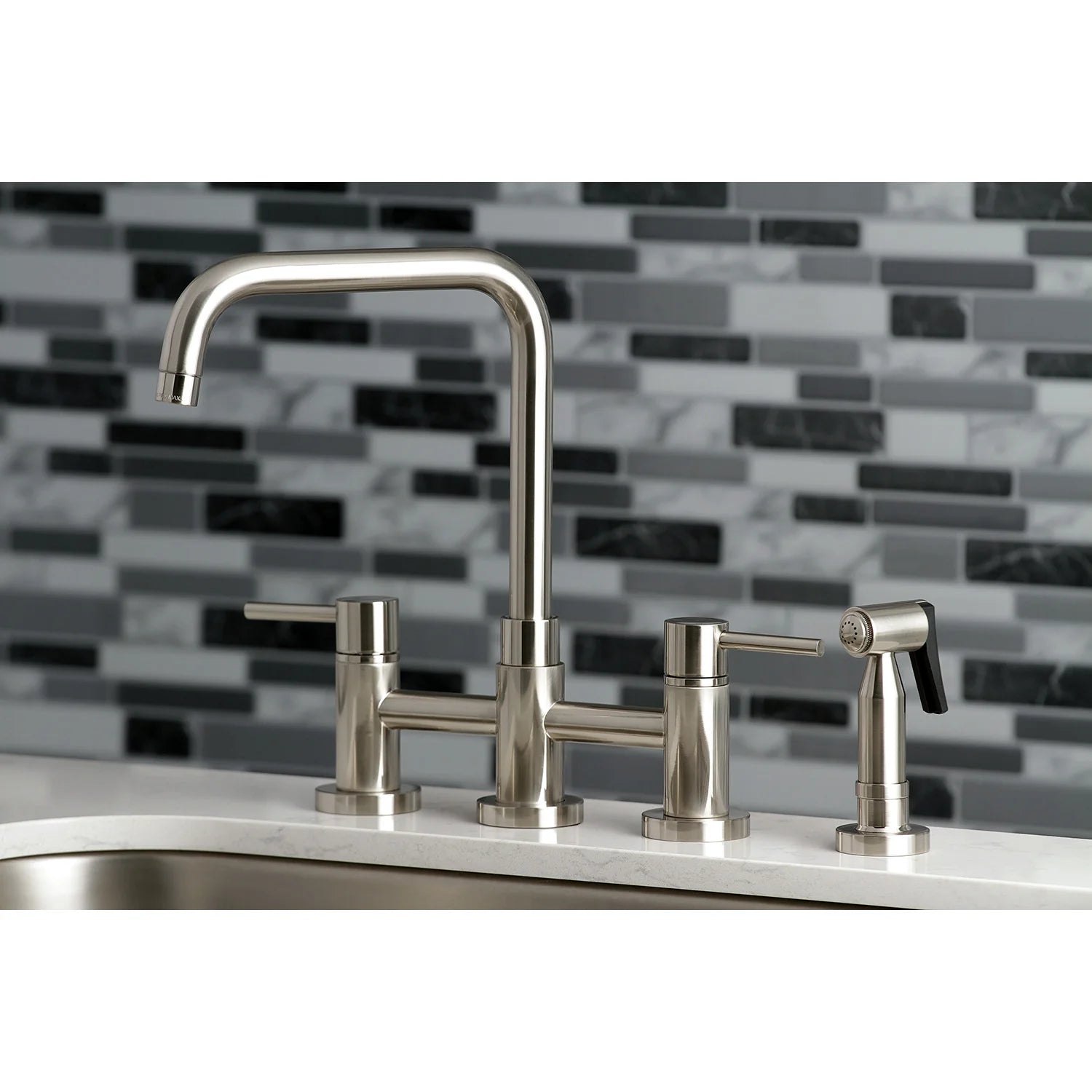 Brushed nickel bridge kitchen faucet with side sprayer and three separate controls