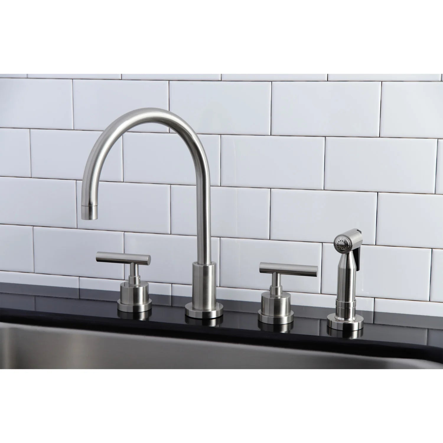 Brushed nickel widespread kitchen faucet with sprayer and dual lever handles on sink