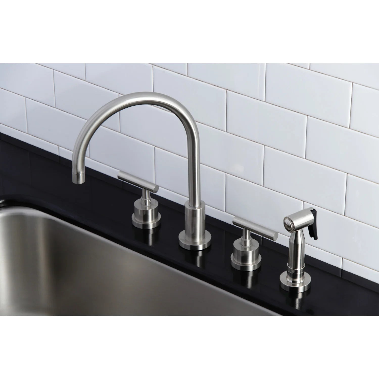 Brushed nickel widespread kitchen faucet with sprayer and two handles mounted on sink