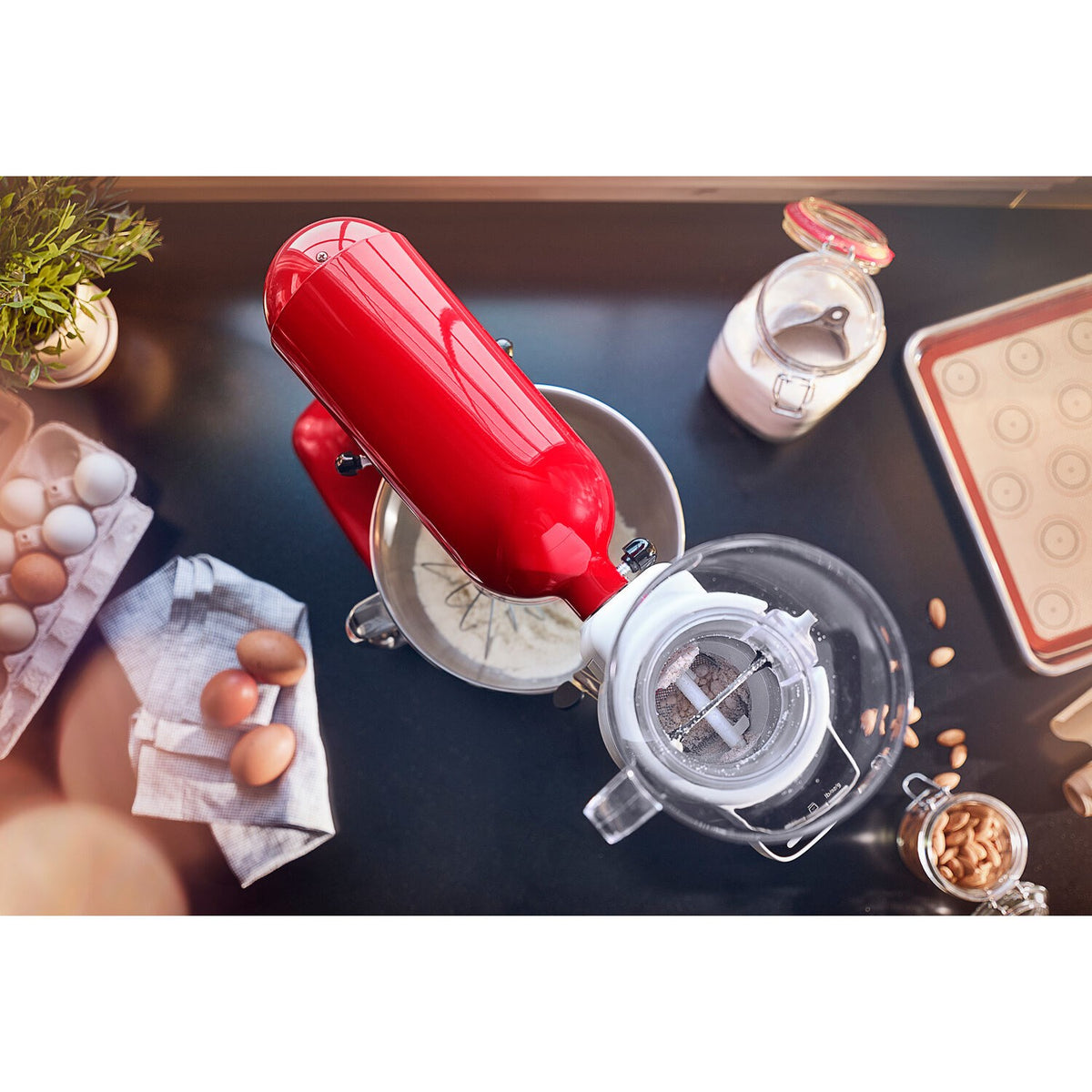 Red mixer with clear sifter chamber and metal mesh screen for fine ingredients