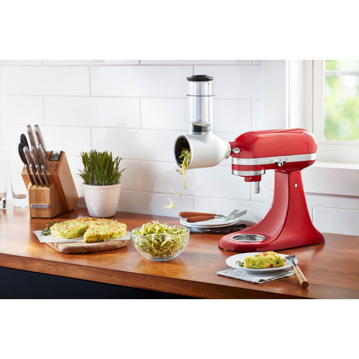 KitchenAid Fresh Prep slicer/shredder attachment on red stand mixer with sliced toppings