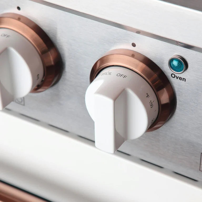 White propane range control panel with rose gold knobs and blue indicator light