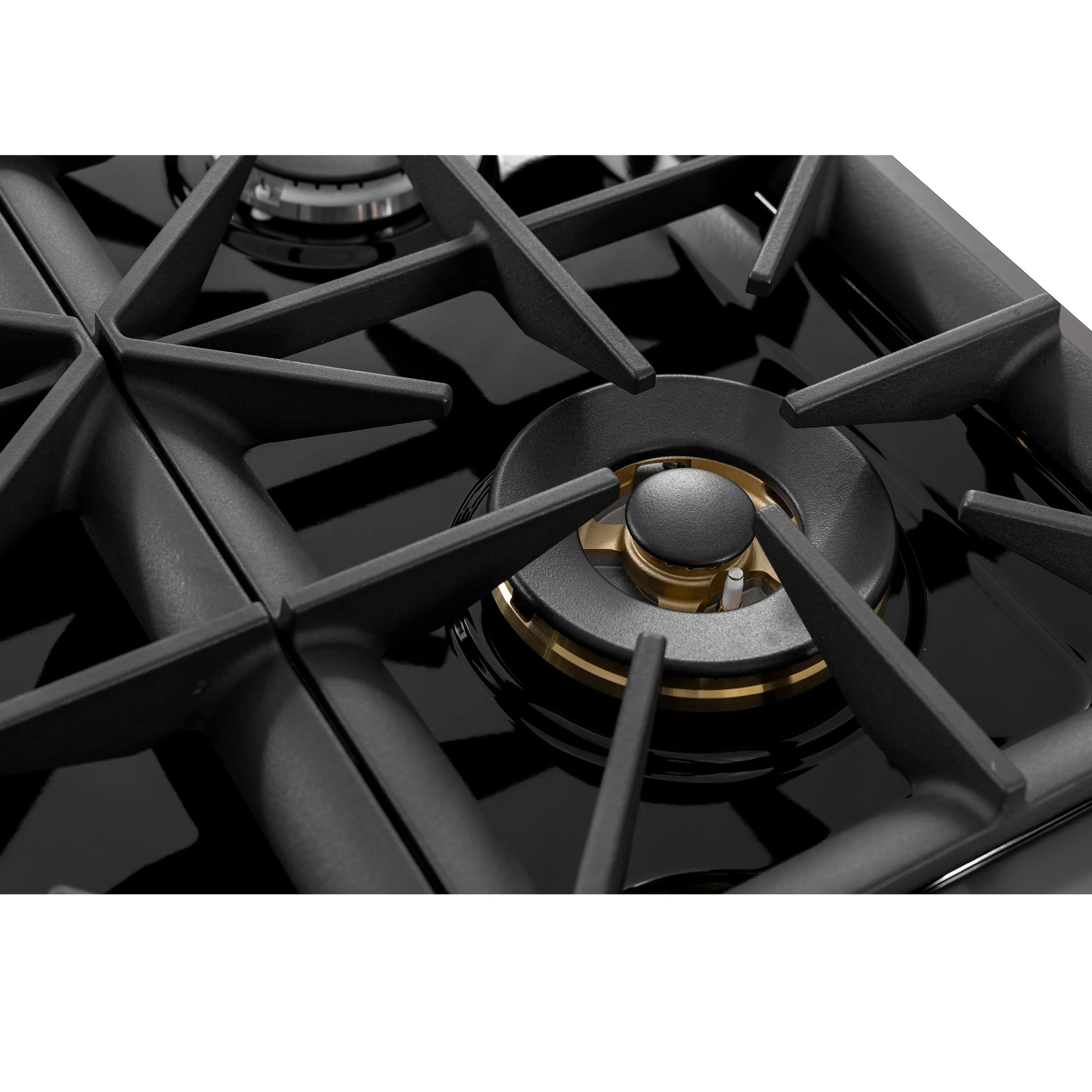 Gas burner with black cast-iron grates and a round burner cap with golden accent