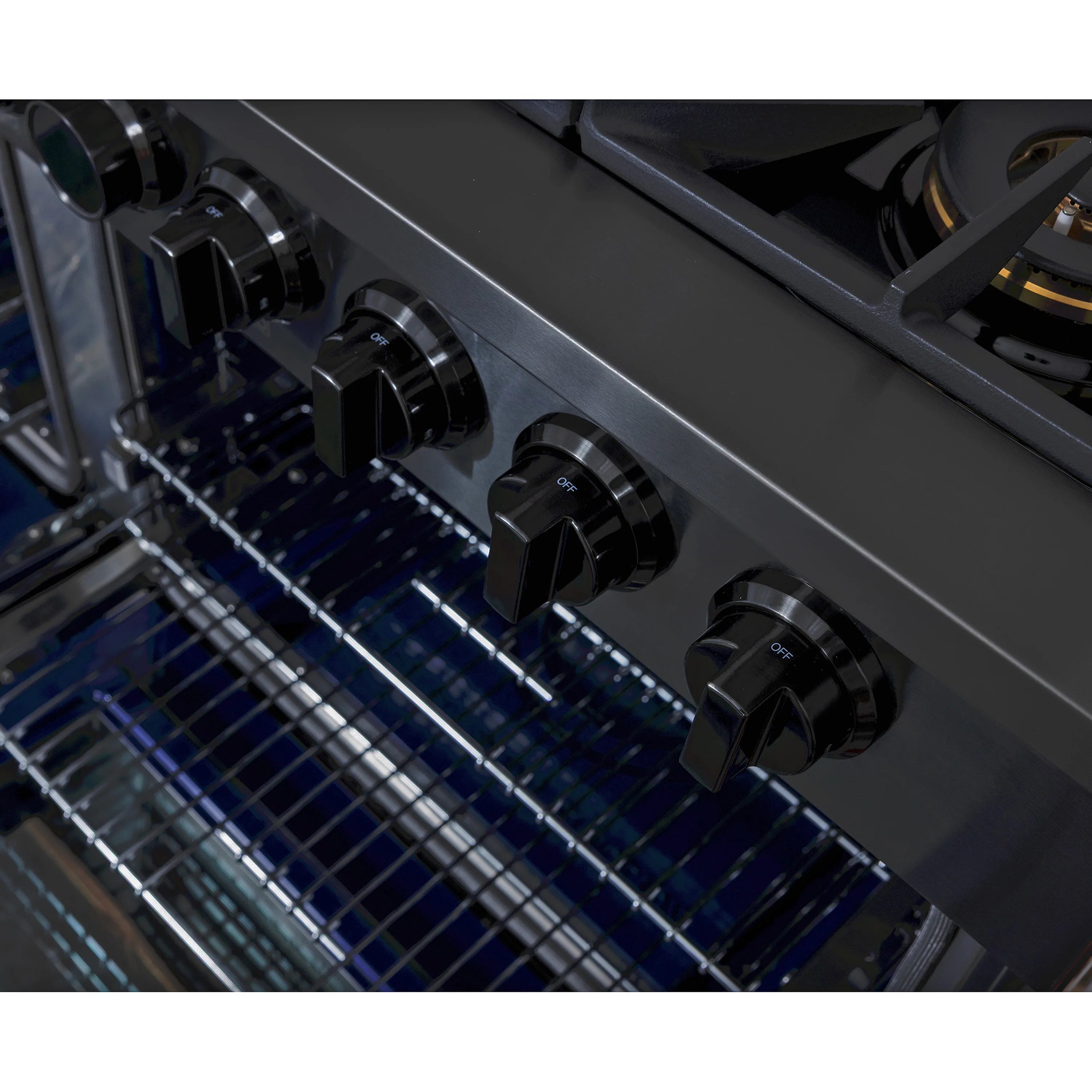 Oven interior with wire racks under interior light and control knobs on the front panel