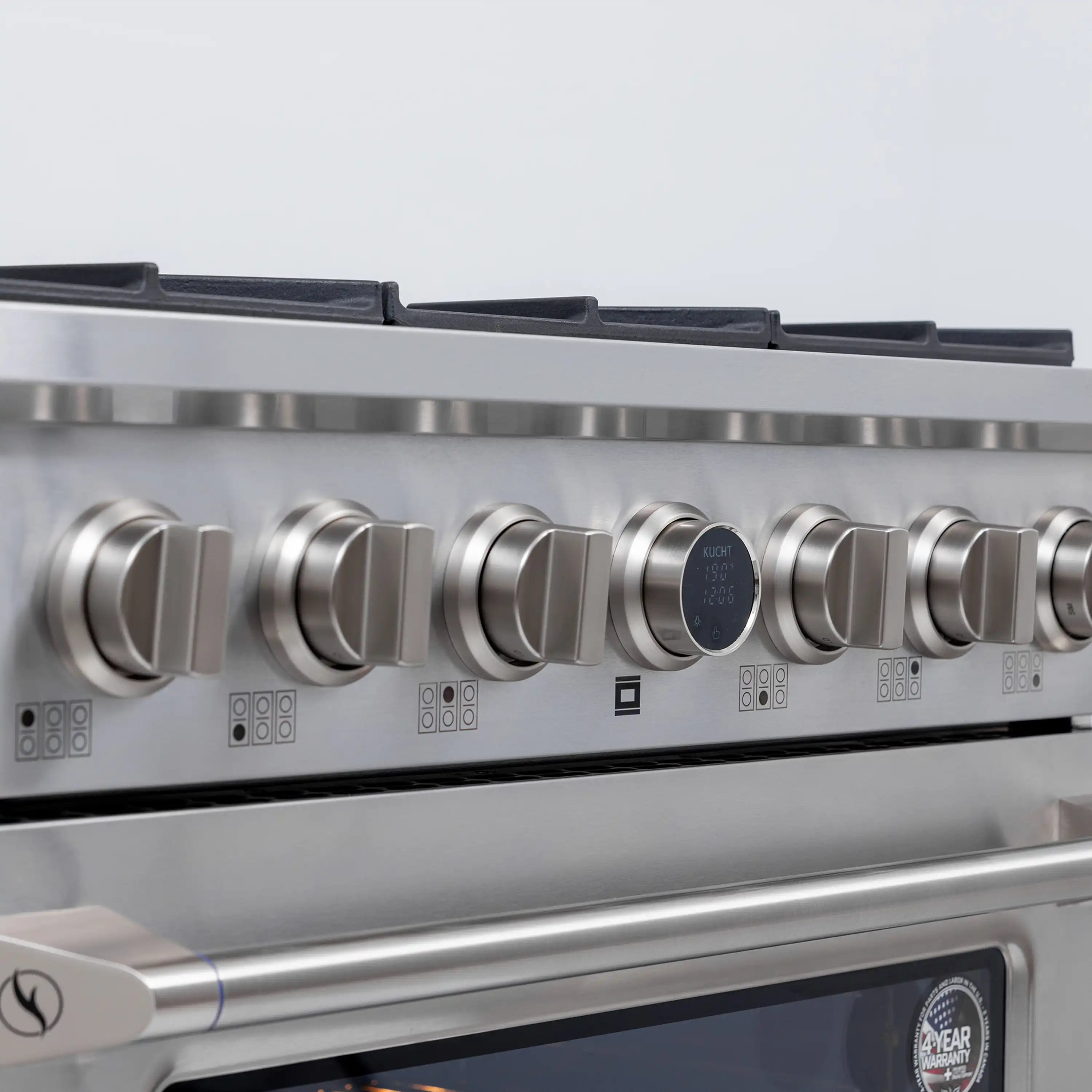 Stainless steel control panel with multiple round knobs and digital display near oven