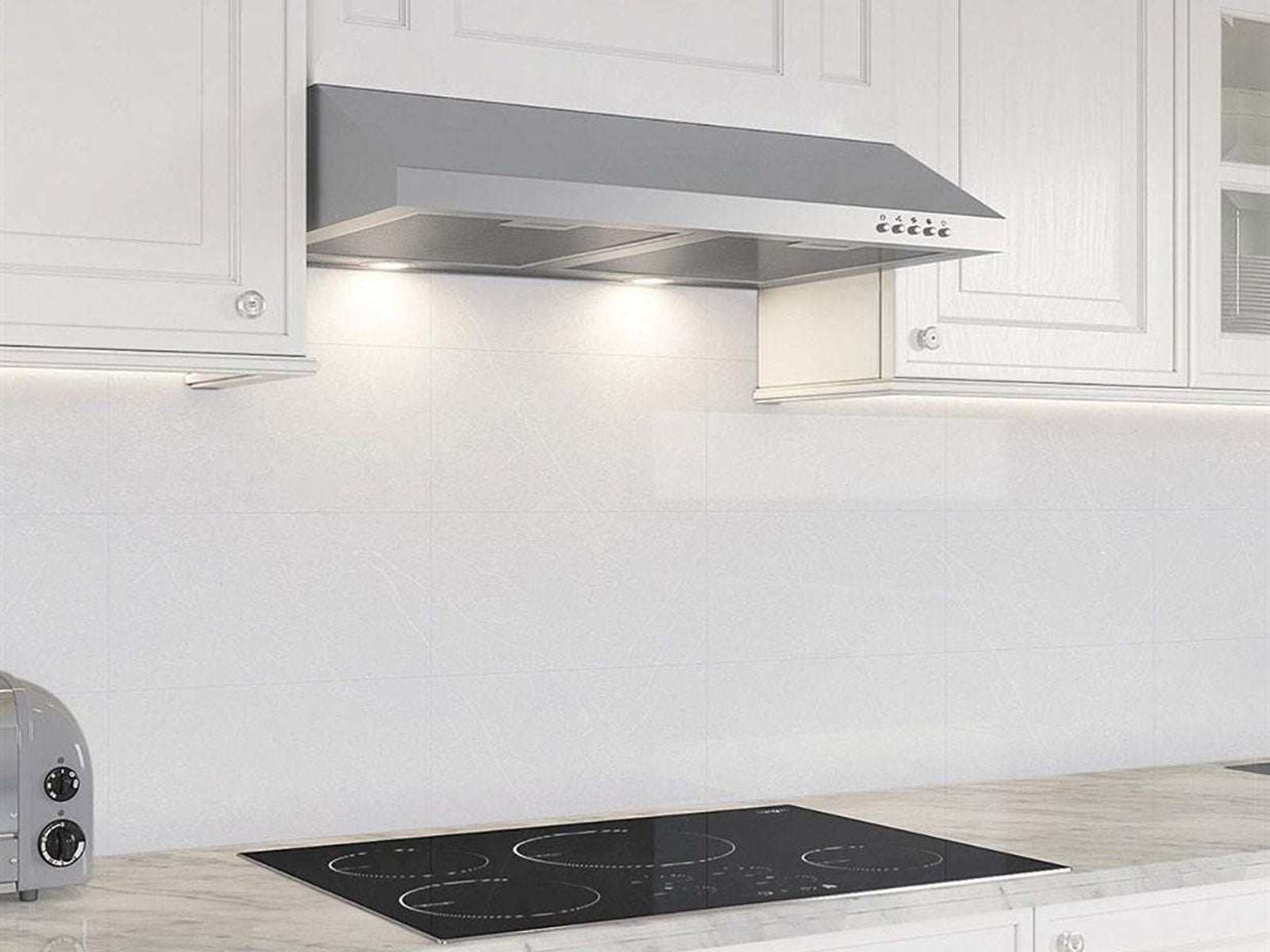 Under-cabinet stainless range hood vent hood above an electric cooktop