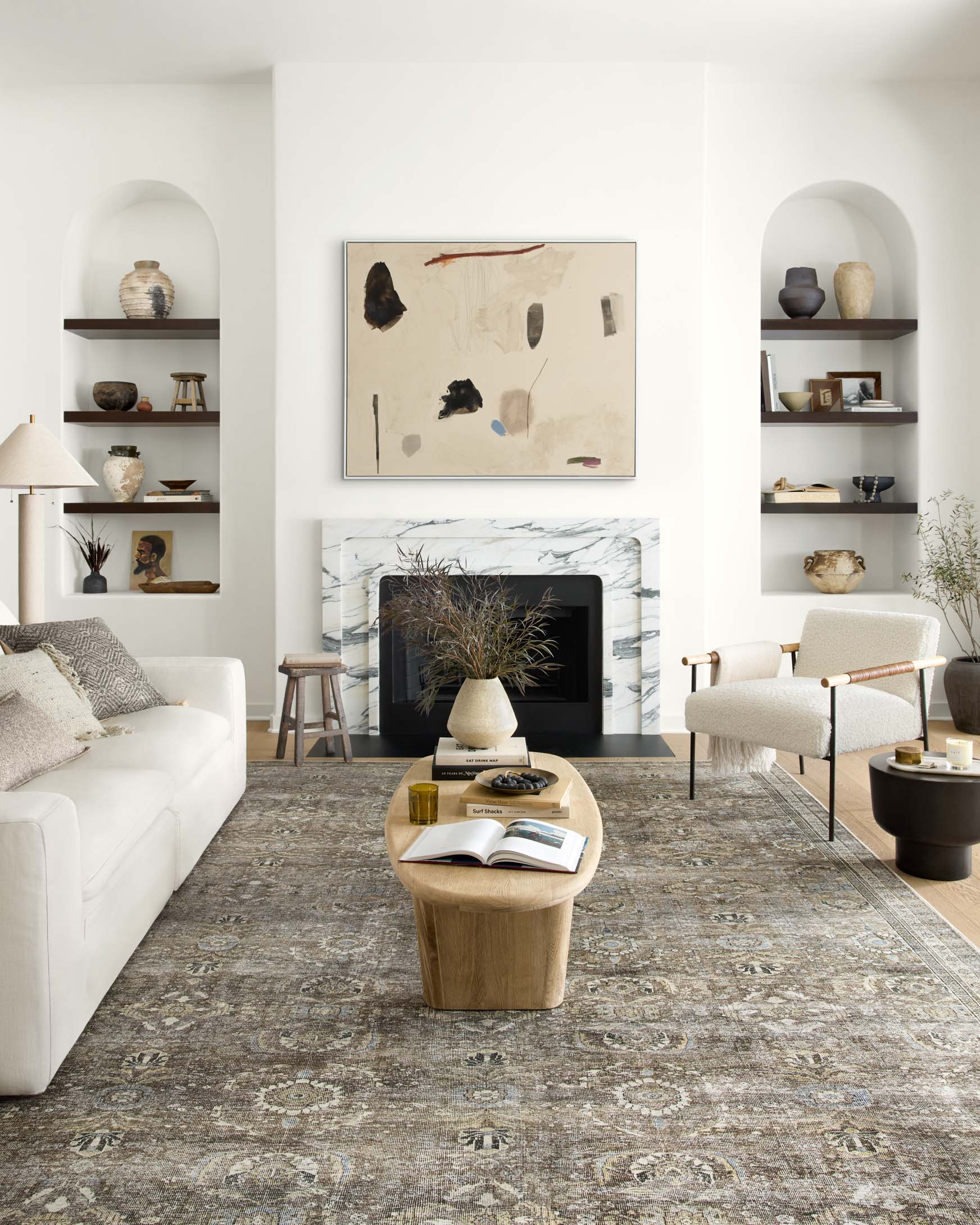 Traditional area rug with dense distressed medallion pattern, antique gray with tan accents