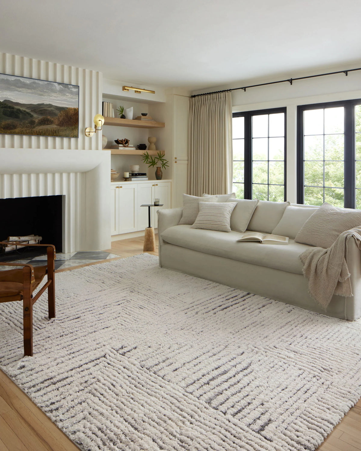 Ivory and grey shag accent rug laid in a living room, visible corner and pile
