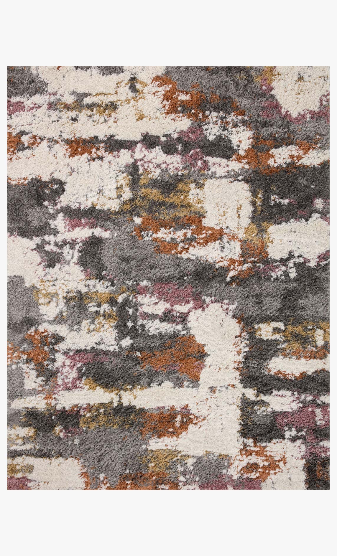 Close-up of shag accent rug texture with grey, cream, orange and pink abstract blocks
