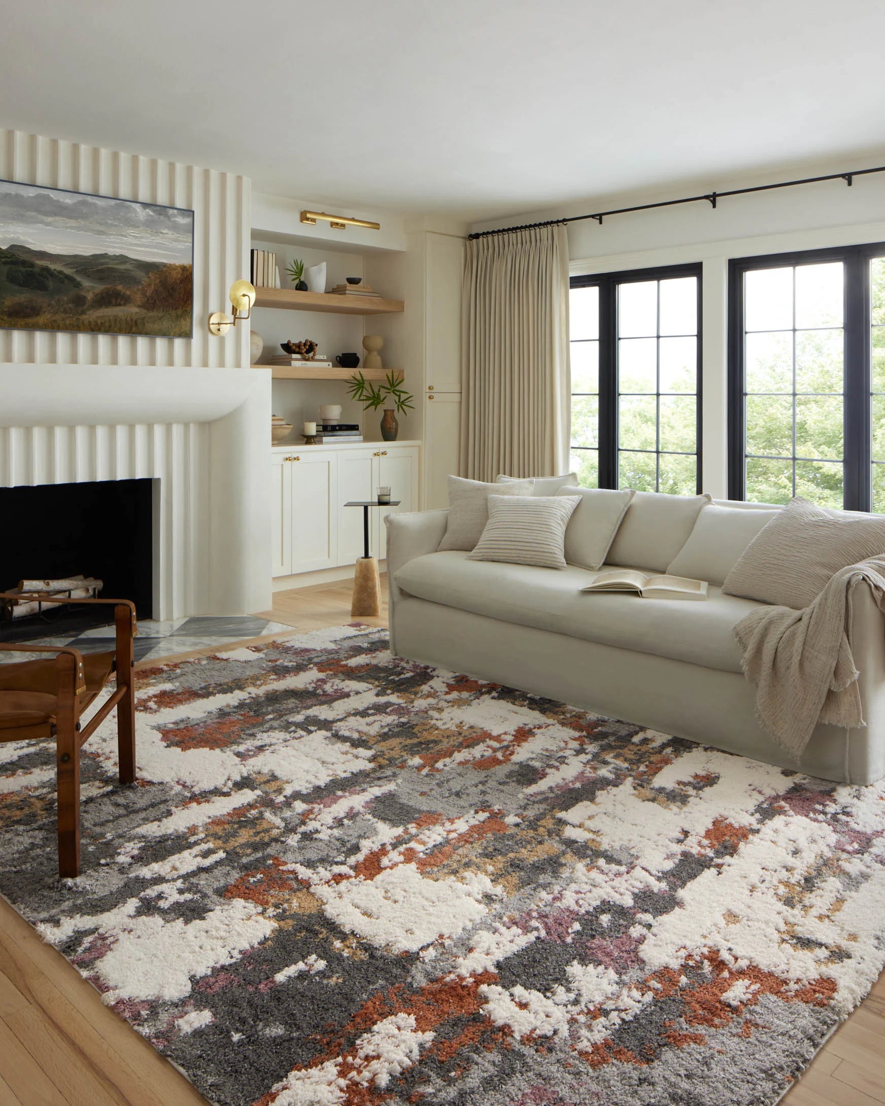 Grey shag accent rug with cream, orange and pink distressed pattern, full rug view.