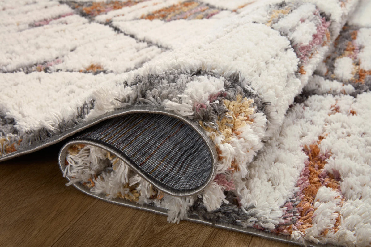 Ivory shag rug with multicolor striped pattern and plush tufted texture near edge