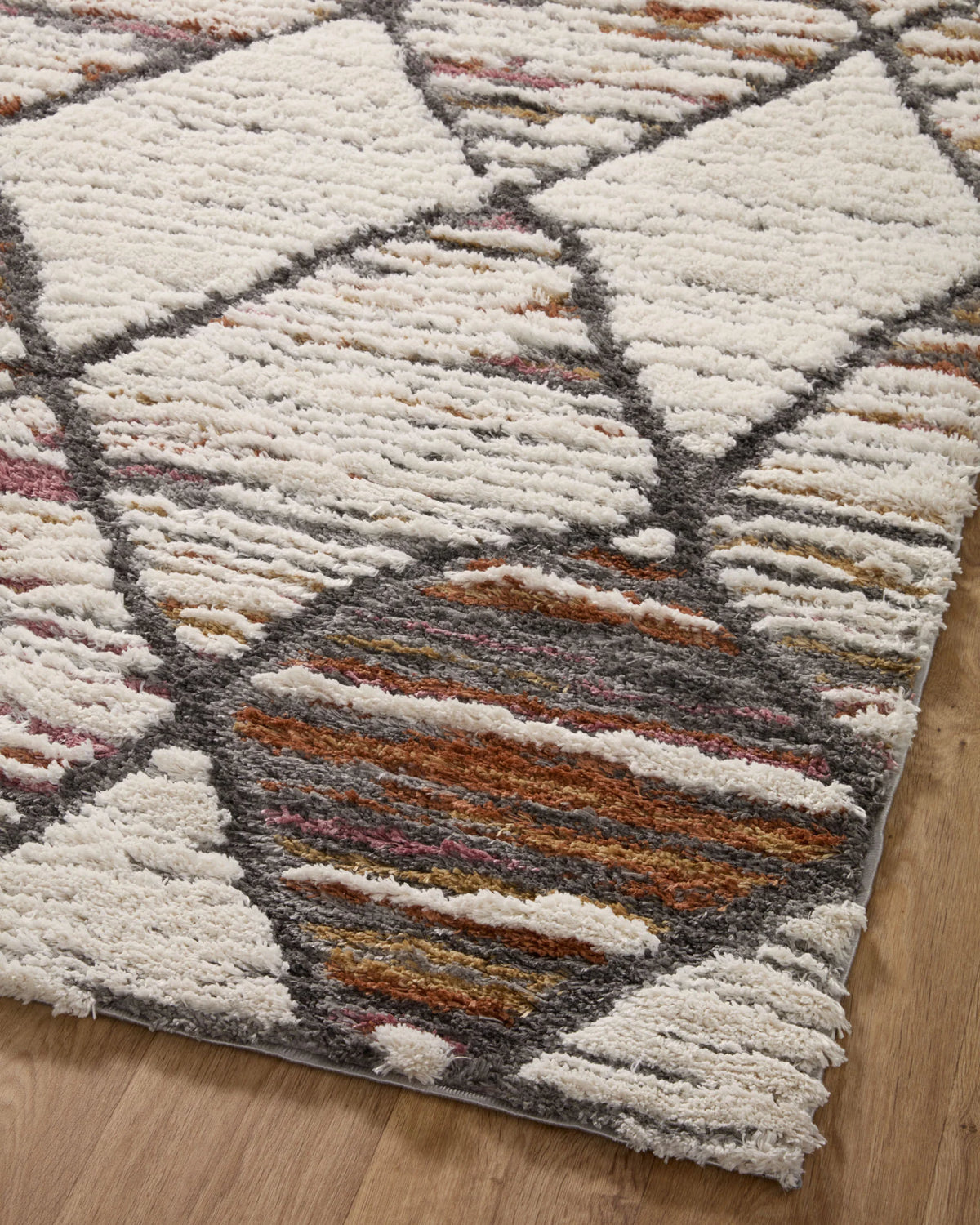 Ivory shag runner rug with diamond pattern in gray, orange, and muted rust tones
