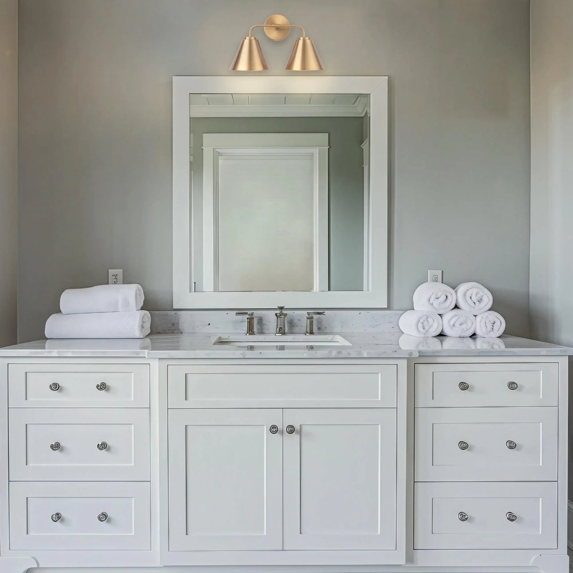 Golden 2-light vanity light with two conical shades and curved metal bar mounting