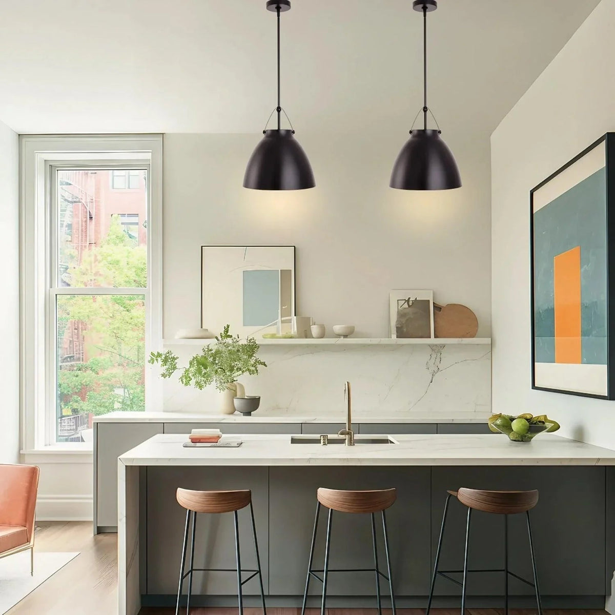 Black 1-light pendant light with tapered metal dome shade suspended over island