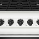 Close-up of white range control knobs across the cooktop panel