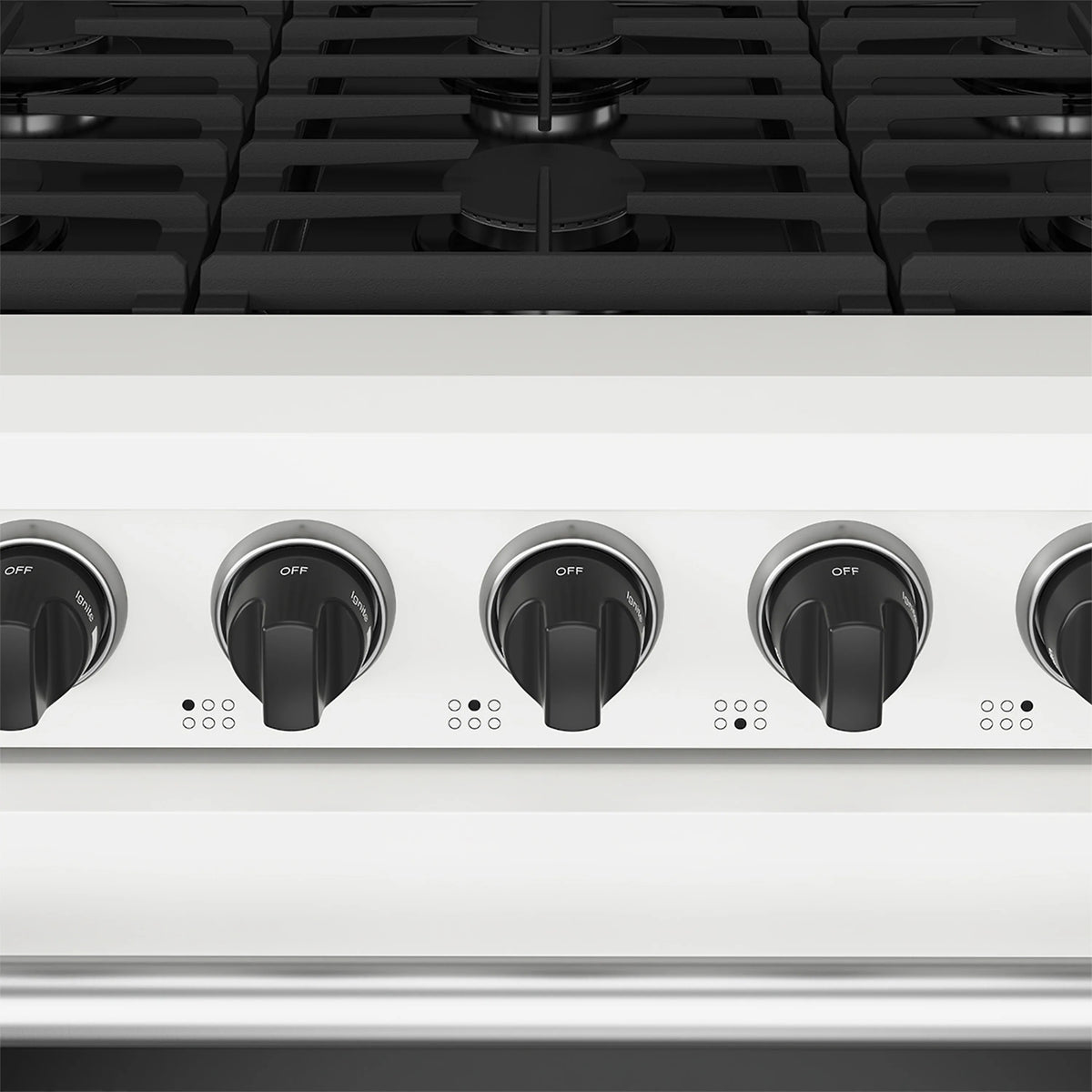 Close-up of white range control knobs across the cooktop panel