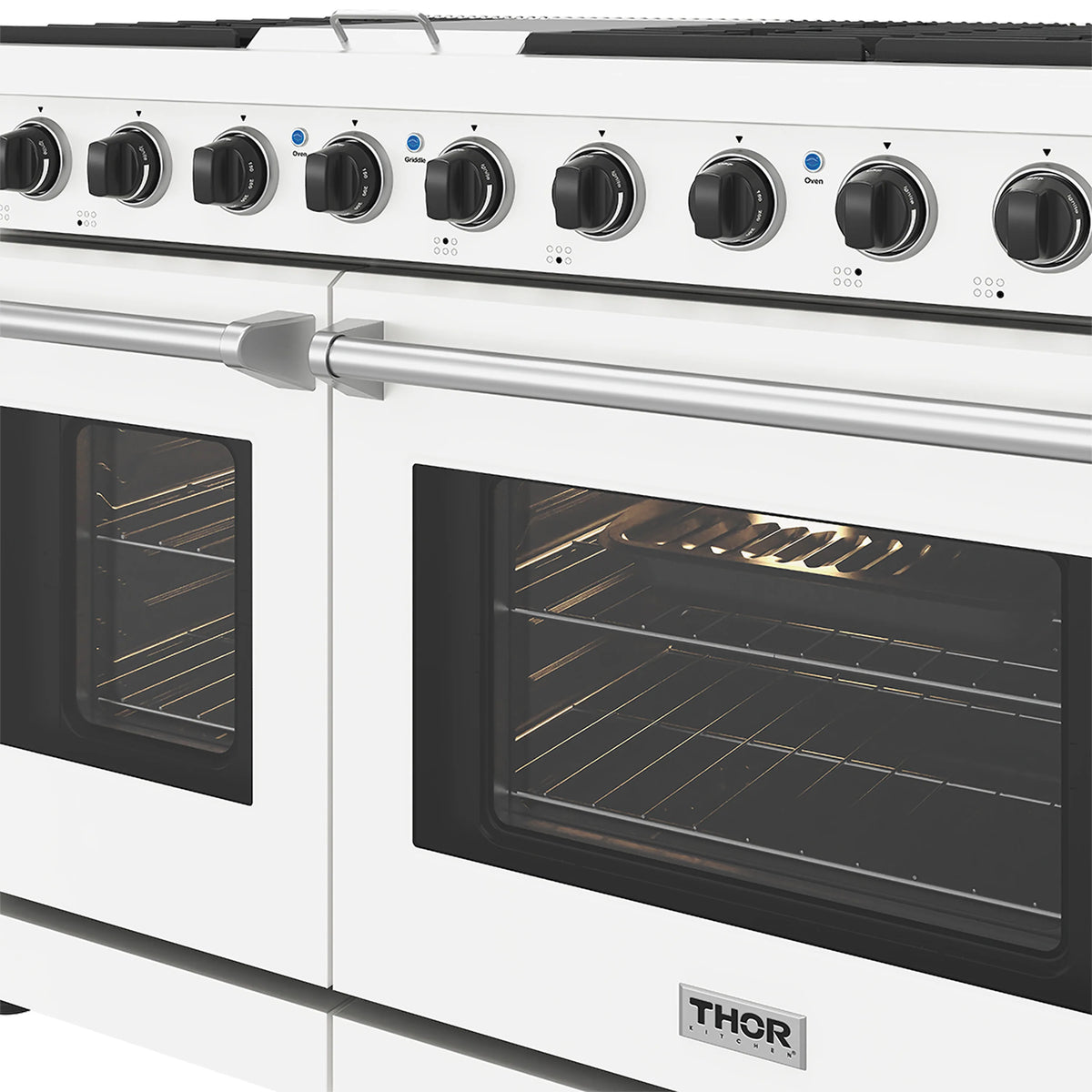 Close-up of white gas range control knobs and dual black oven doors