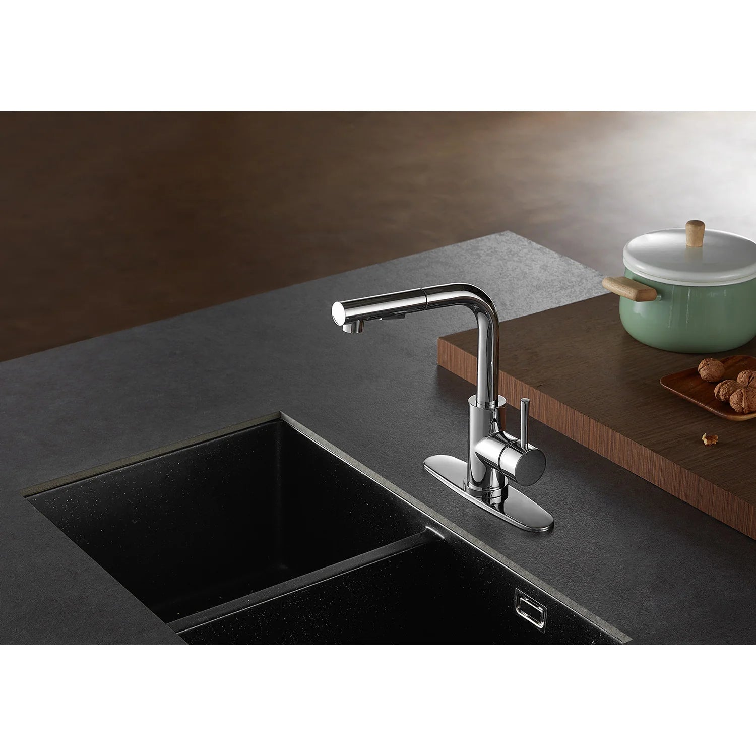 Polished chrome pull-out kitchen faucet with sprayer extended over sink