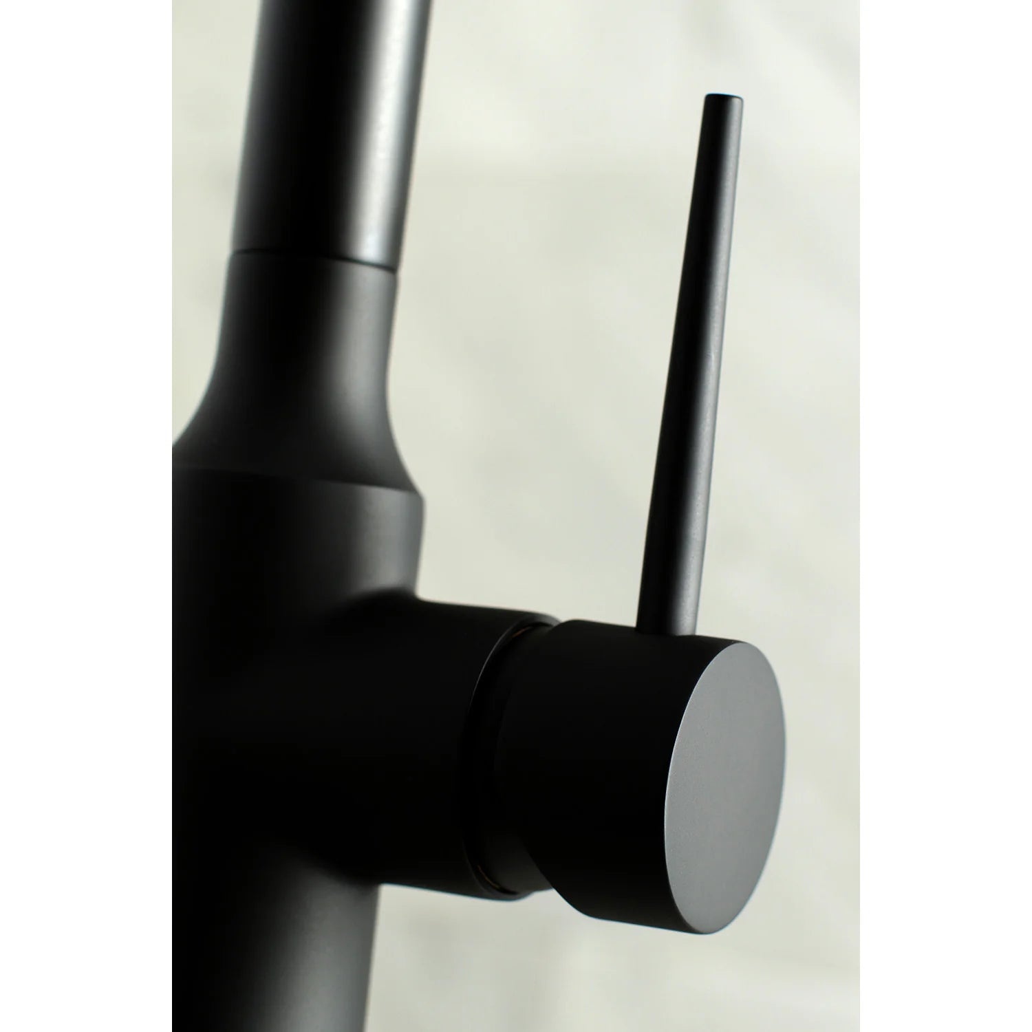 Matte black faucet handle and cylindrical control with pull-down hose connection