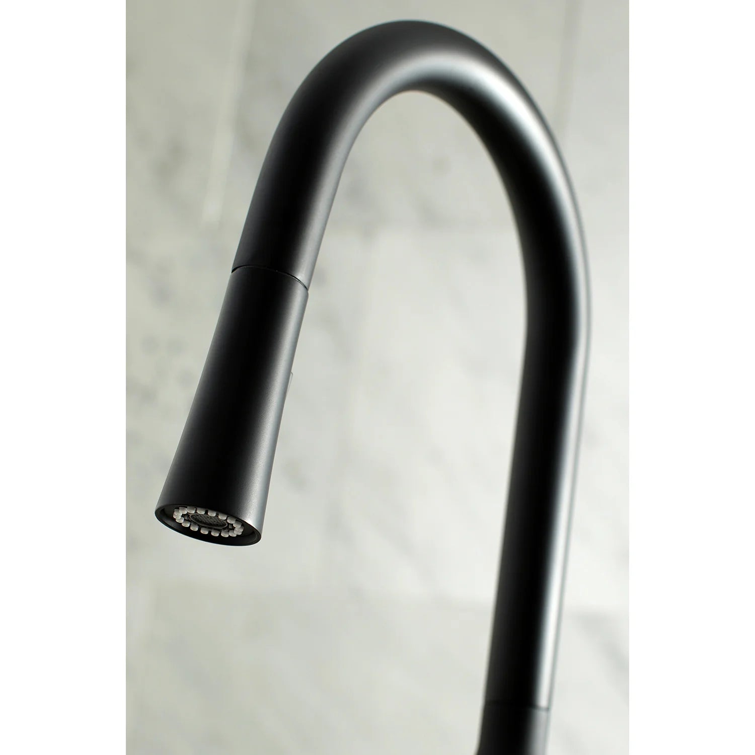 Matte black arched spout kitchen faucet with pull-down spray head attachment