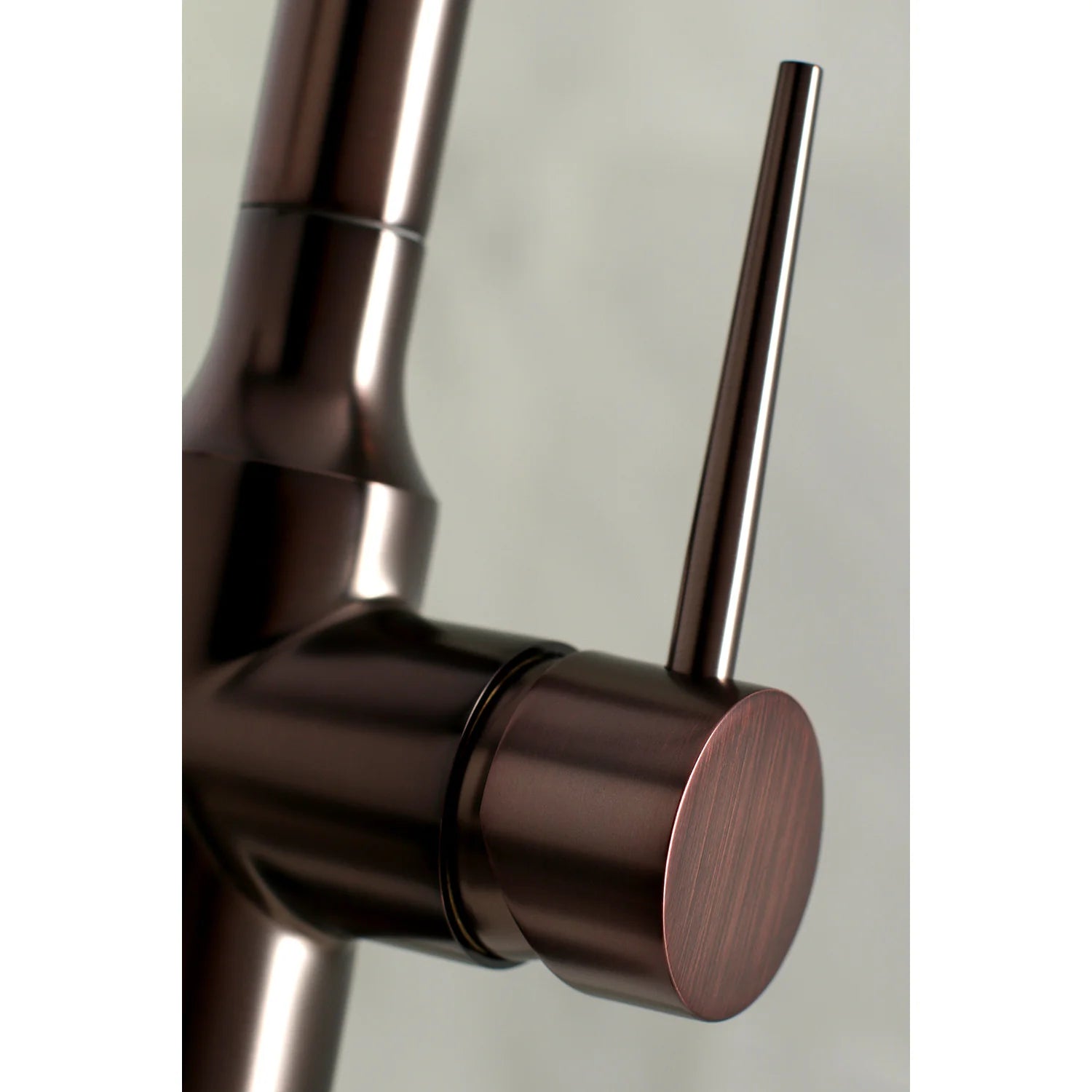 Oil rubbed bronze faucet handle with circular control cap and matching spout body