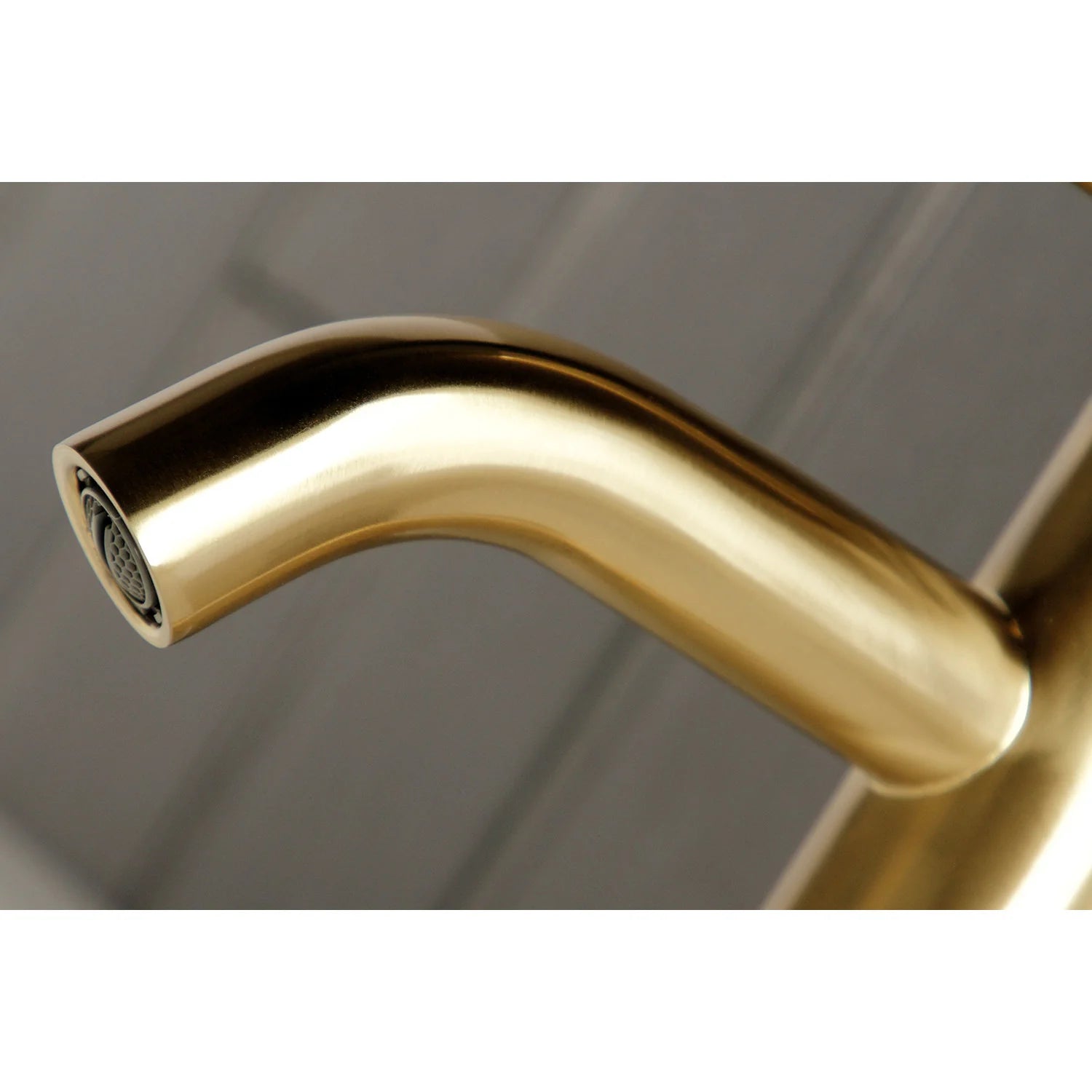 Brushed brass faucet spout with spray outlet detail