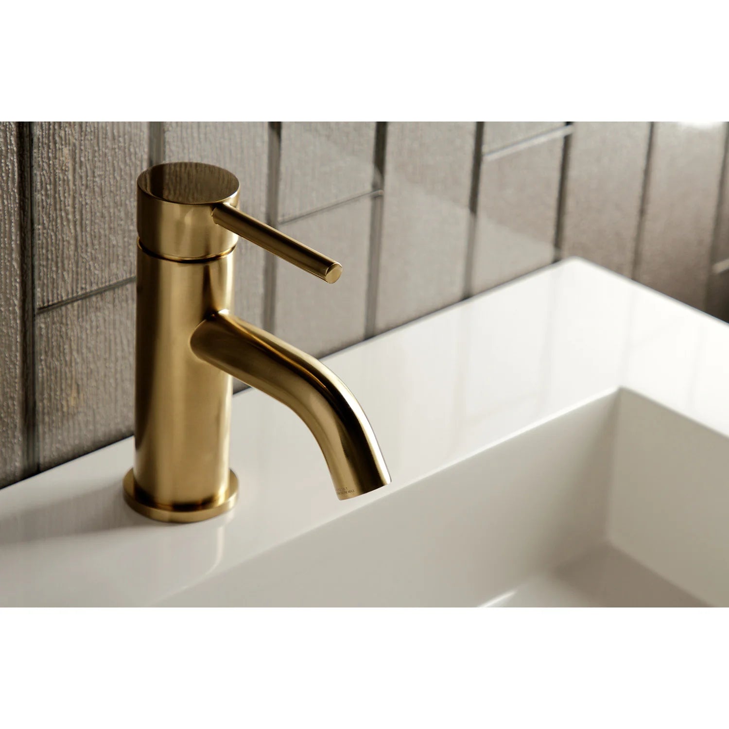 Brushed brass bathroom faucet with tall cylindrical handle and curved spout
