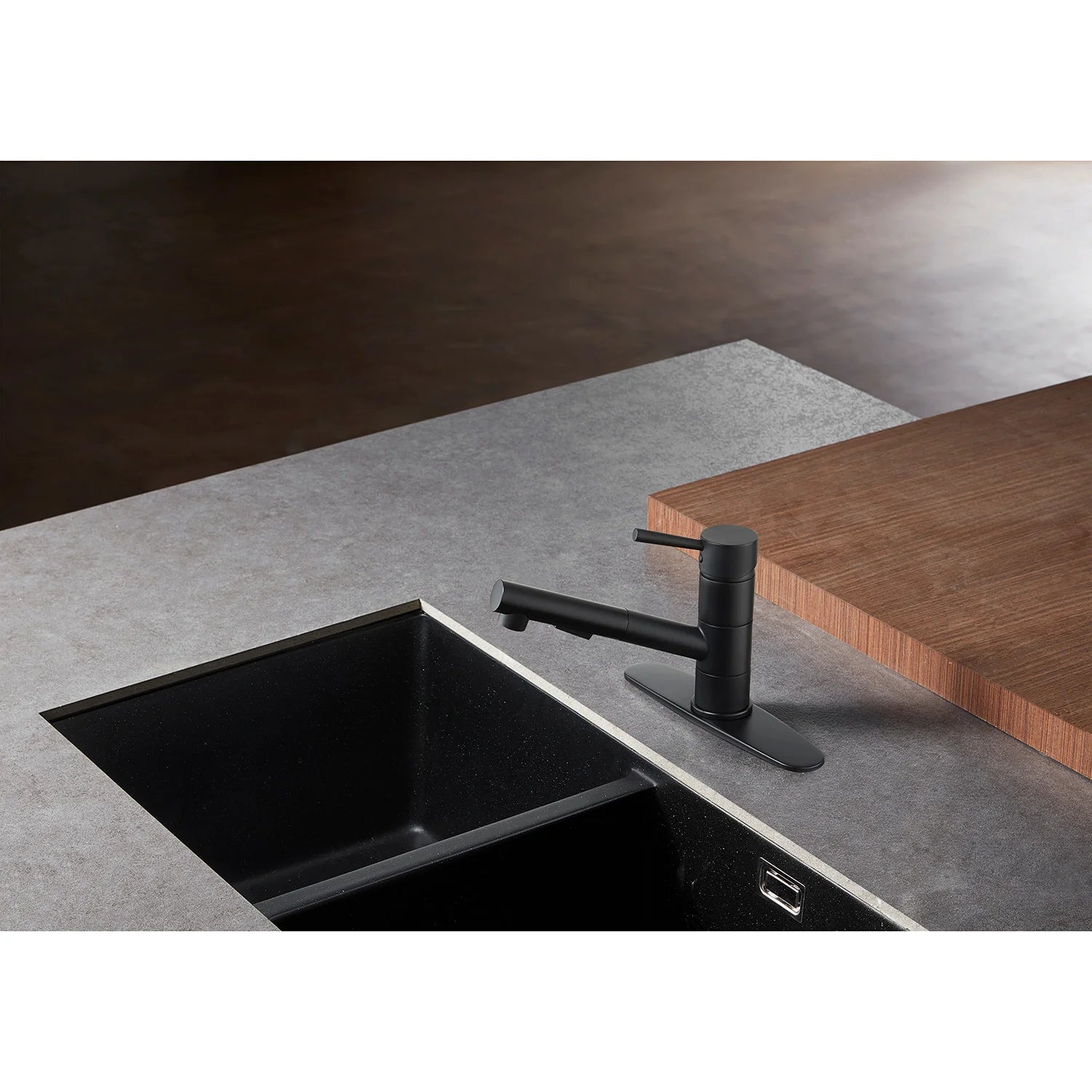 Matte black single-handle pull-out kitchen faucet over sink with pull-down sprayer