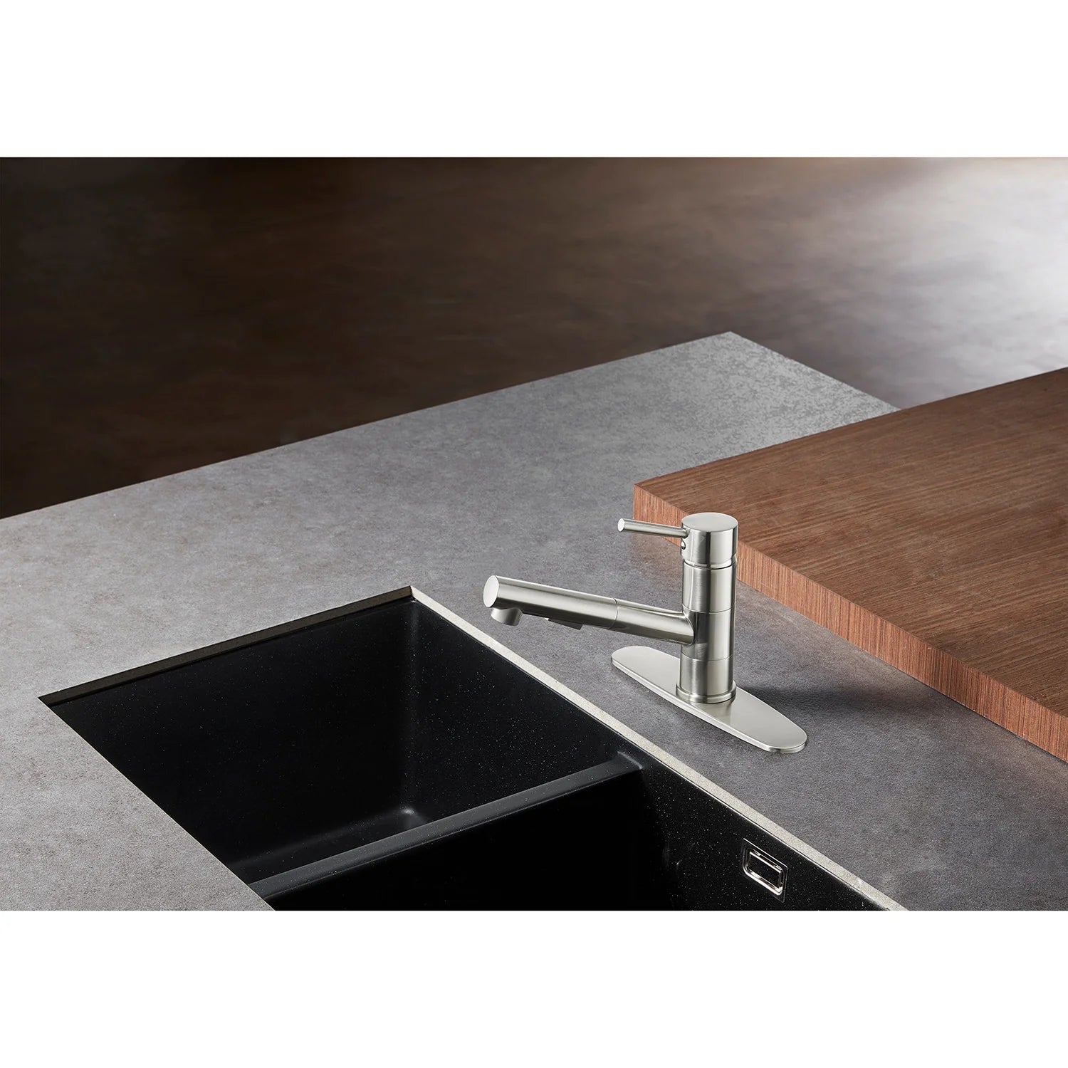 Brushed nickel single-handle pull-out kitchen faucet over sink with deck plate