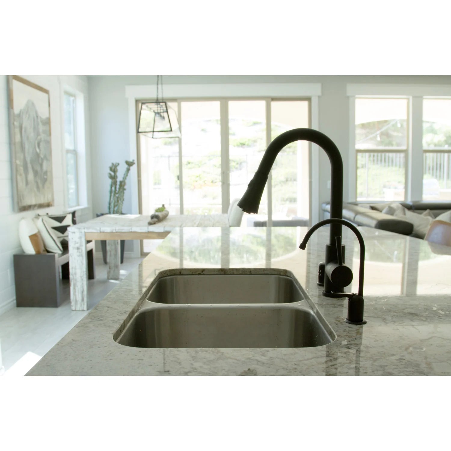 Matte black pull-down kitchen faucet with arched spout above double-basin sink