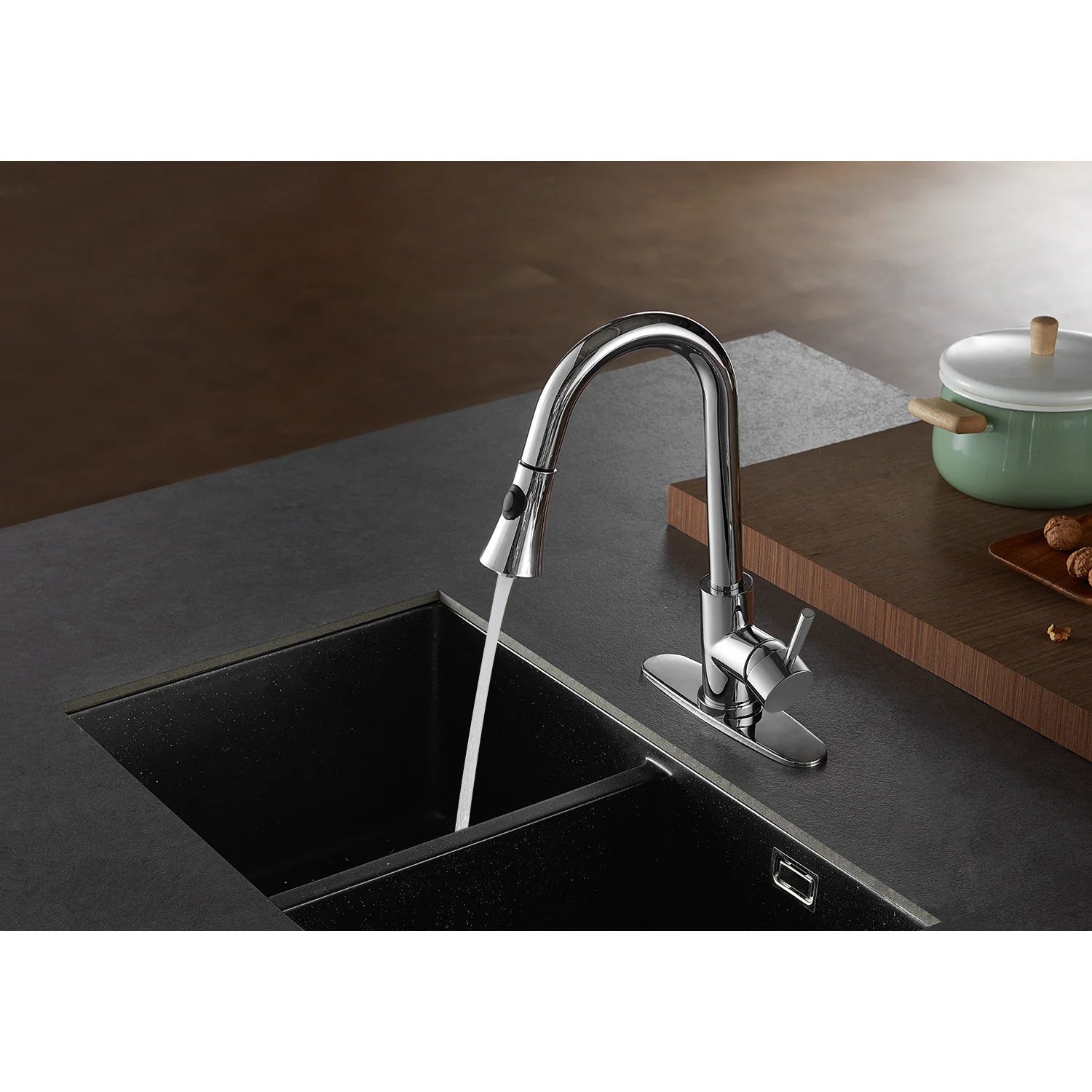 Polished chrome single-handle pull-down kitchen faucet over black sink basin