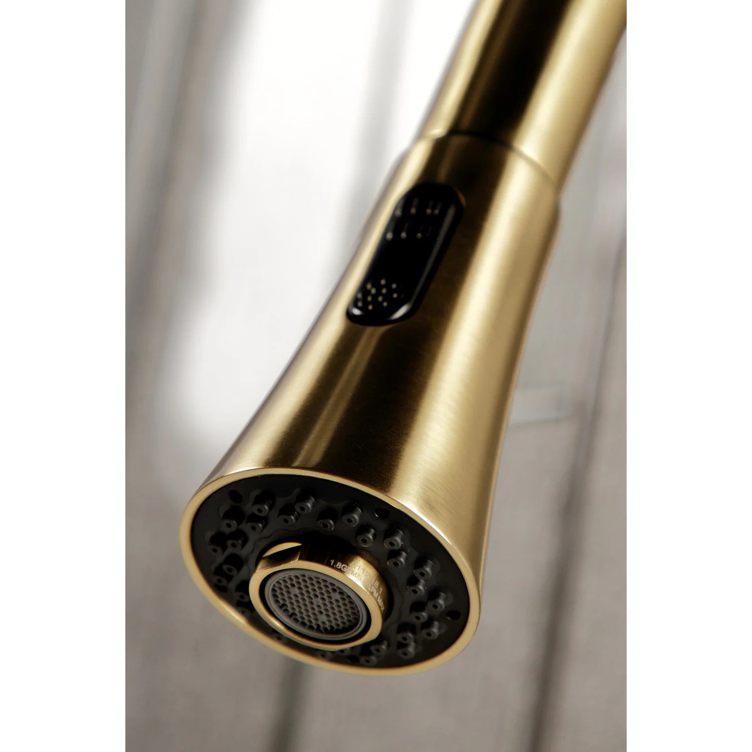 Brushed brass sprayer nozzle head with aerator-style spray face detail