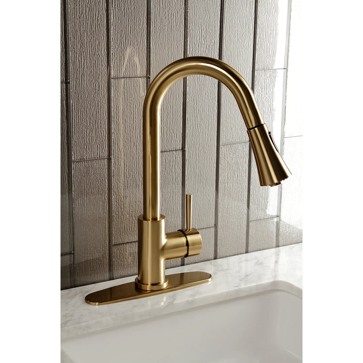 Brushed brass single-handle kitchen faucet with arched spout and pull-down sprayer head
