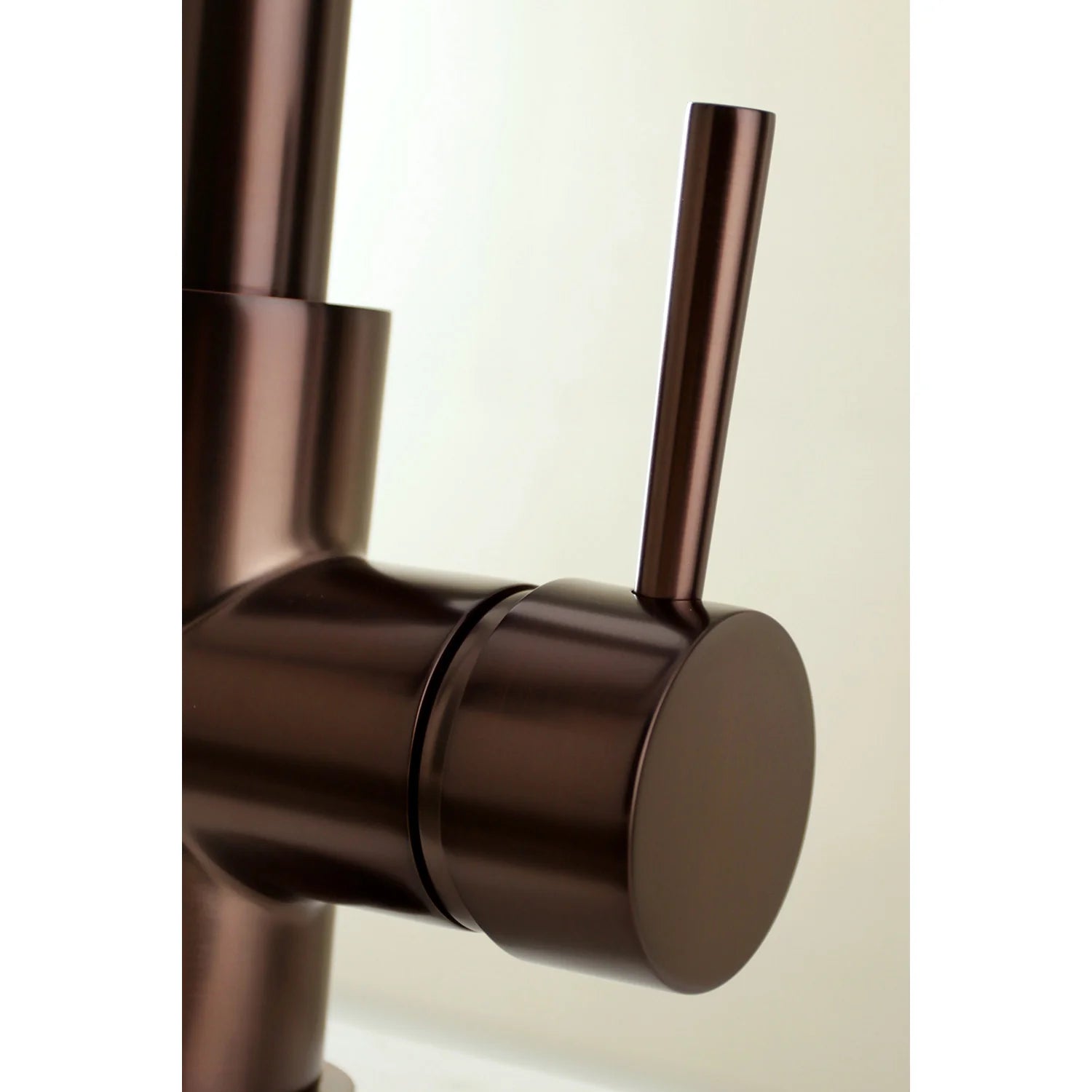 Oil rubbed bronze single-handle faucet handle and flat mounting plate close-up