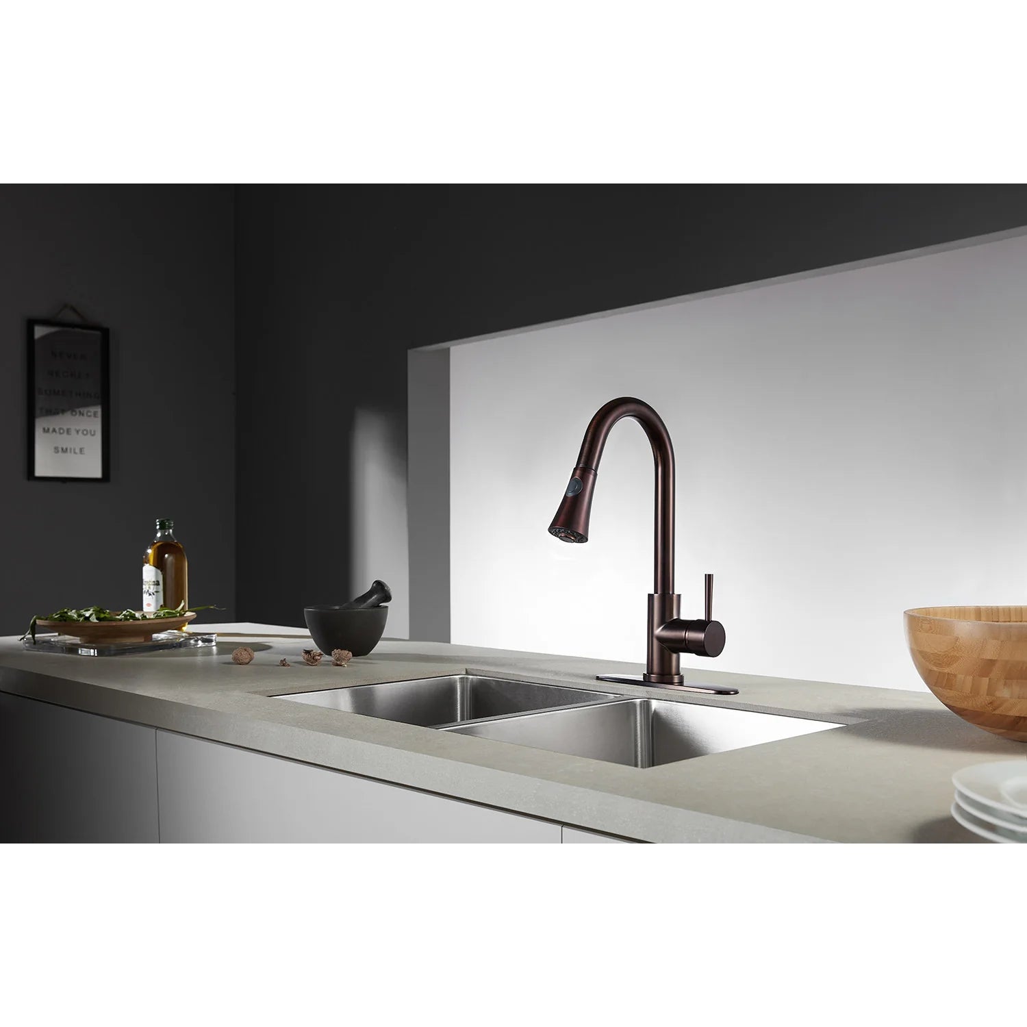 Oil rubbed bronze kitchen faucet with high-arc spout over stainless sink