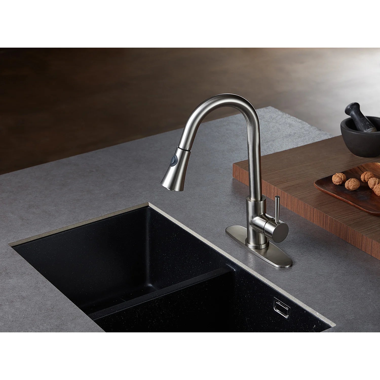 Brushed nickel single-handle pull-down kitchen faucet over a rectangular sink