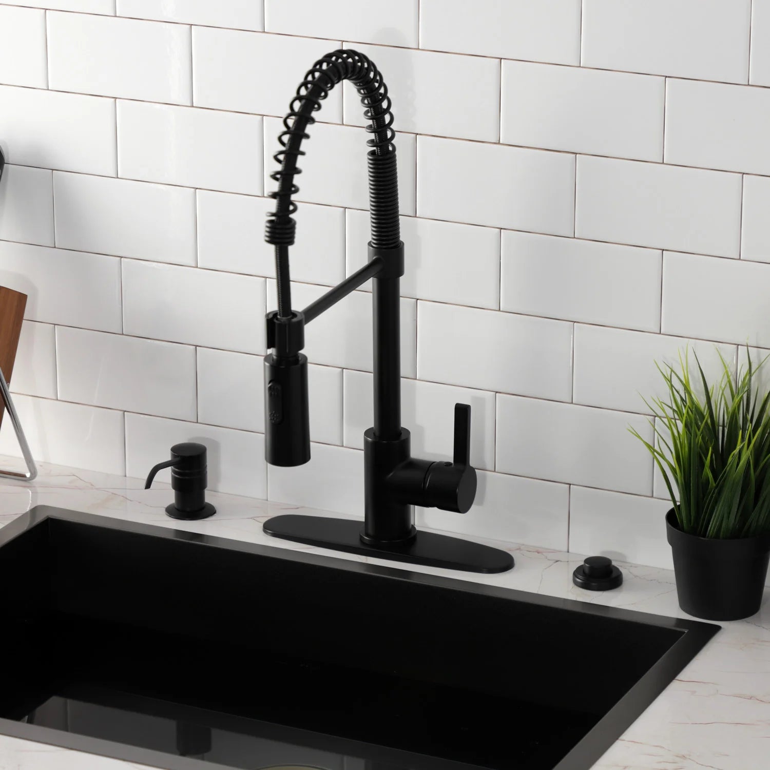 Matte black pre-rinse kitchen faucet with arched sprayer hose and side handle