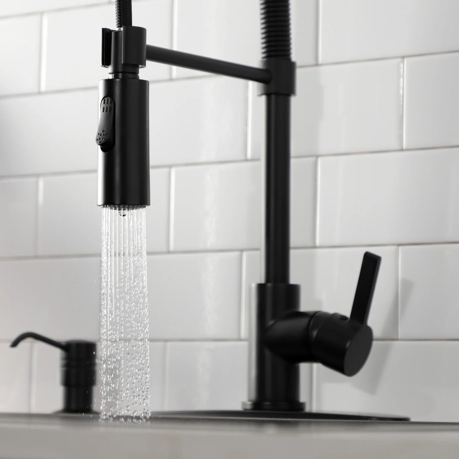 Matte black single-handle deck faucet with pre-rinse spray and side spout