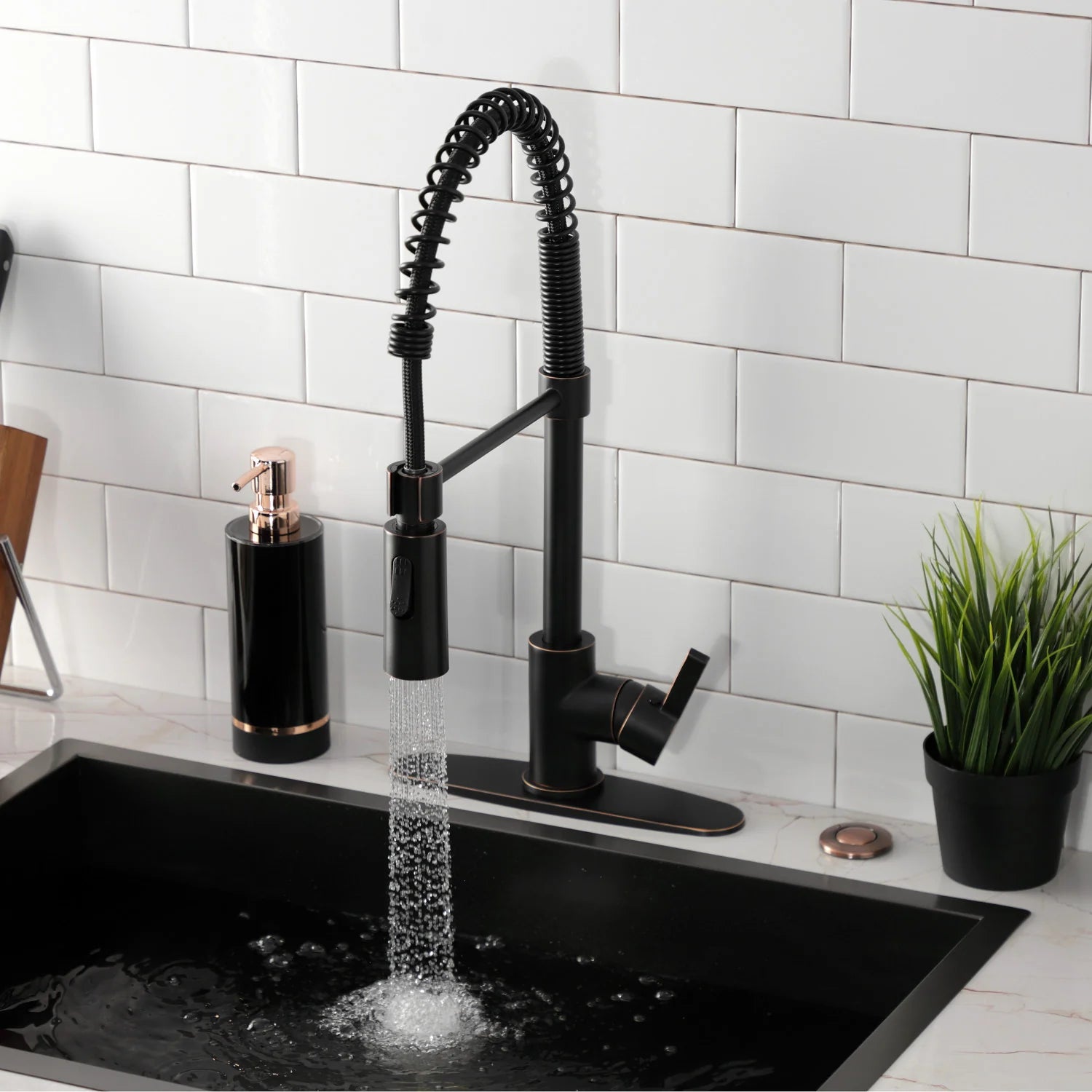 Single-handle pull-down kitchen faucet with black spray head and coiled hose