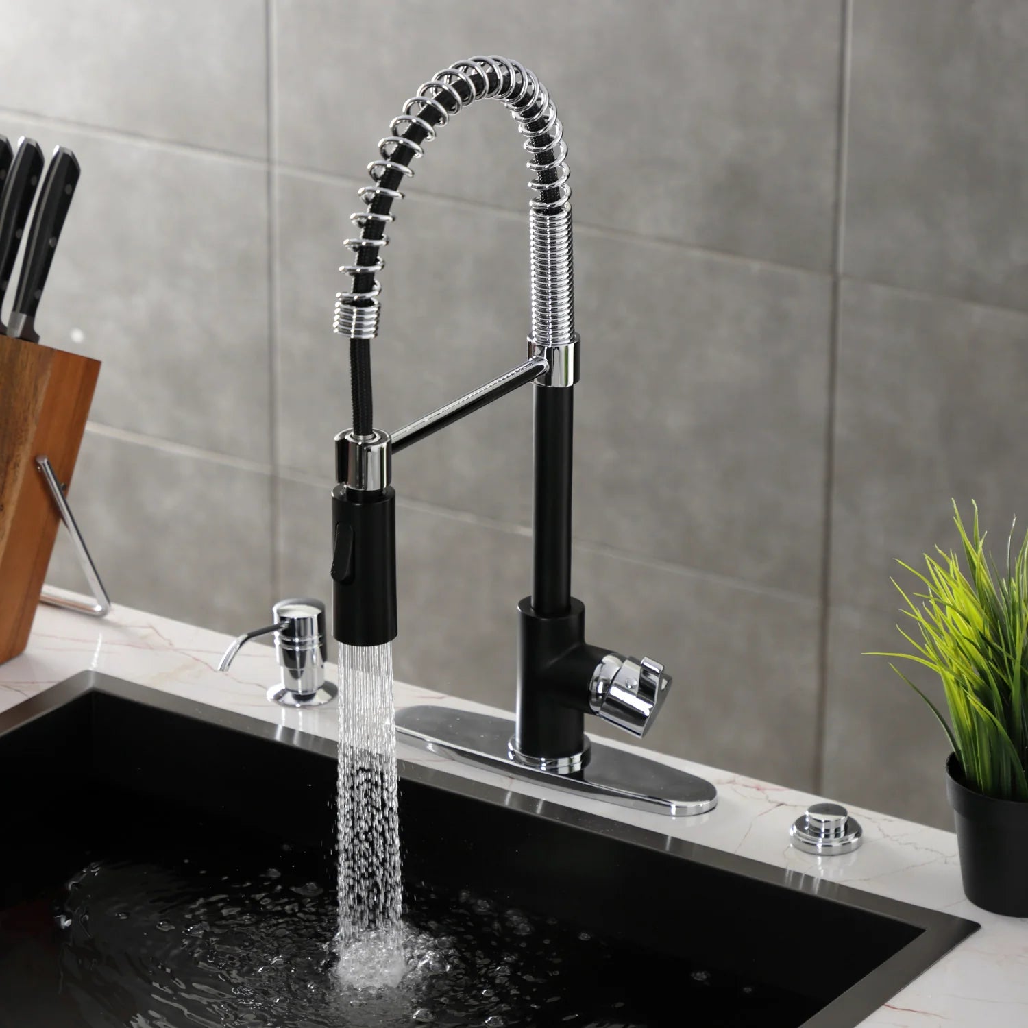 Matte black pre-rinse faucet over sink with flexible hose, chrome spray head, and single lever