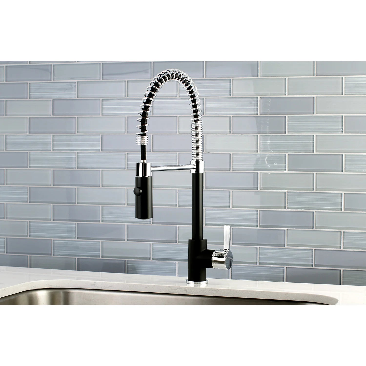 Matte black deck-mount kitchen faucet with single handle, arched hose, and chrome spray head