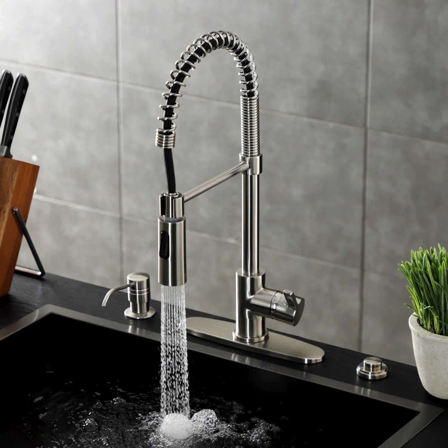 Brushed nickel deck-mount pre-rinse faucet with water stream over sink