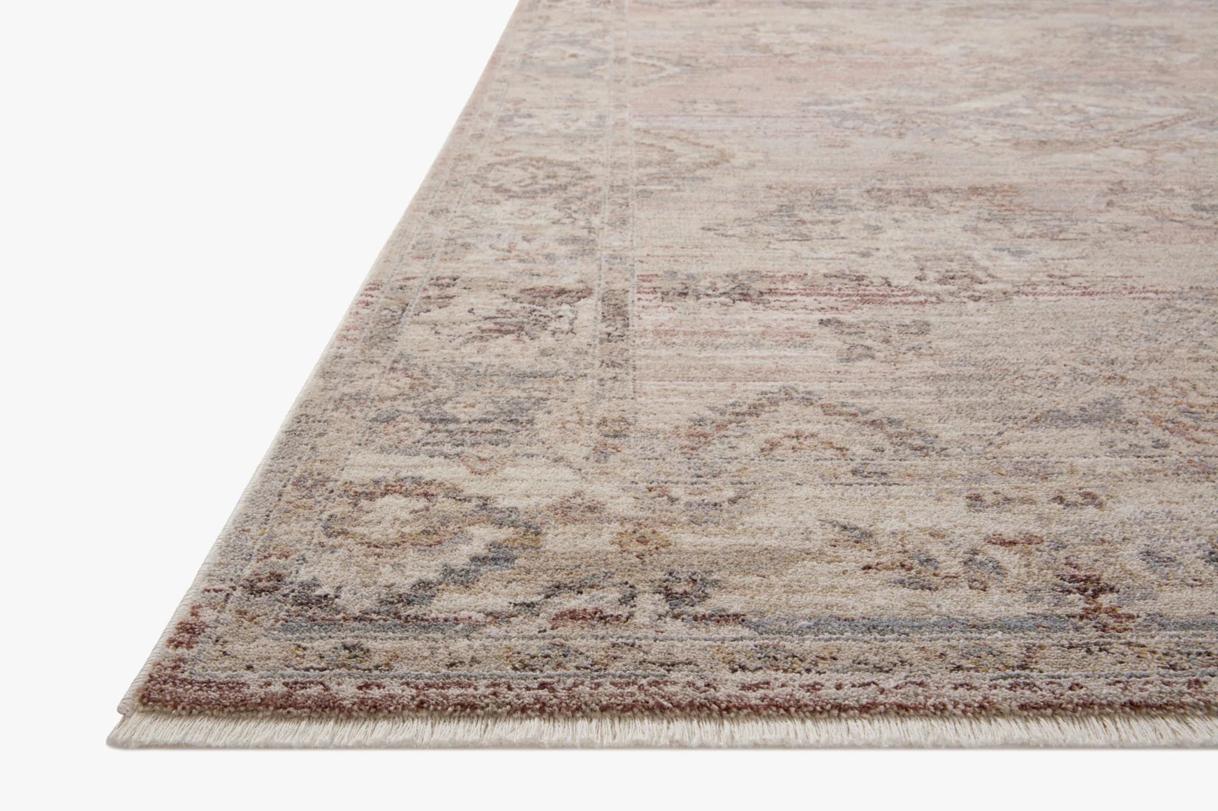 Rectangular area rug with distressed blush and dove pattern, fringed edges
