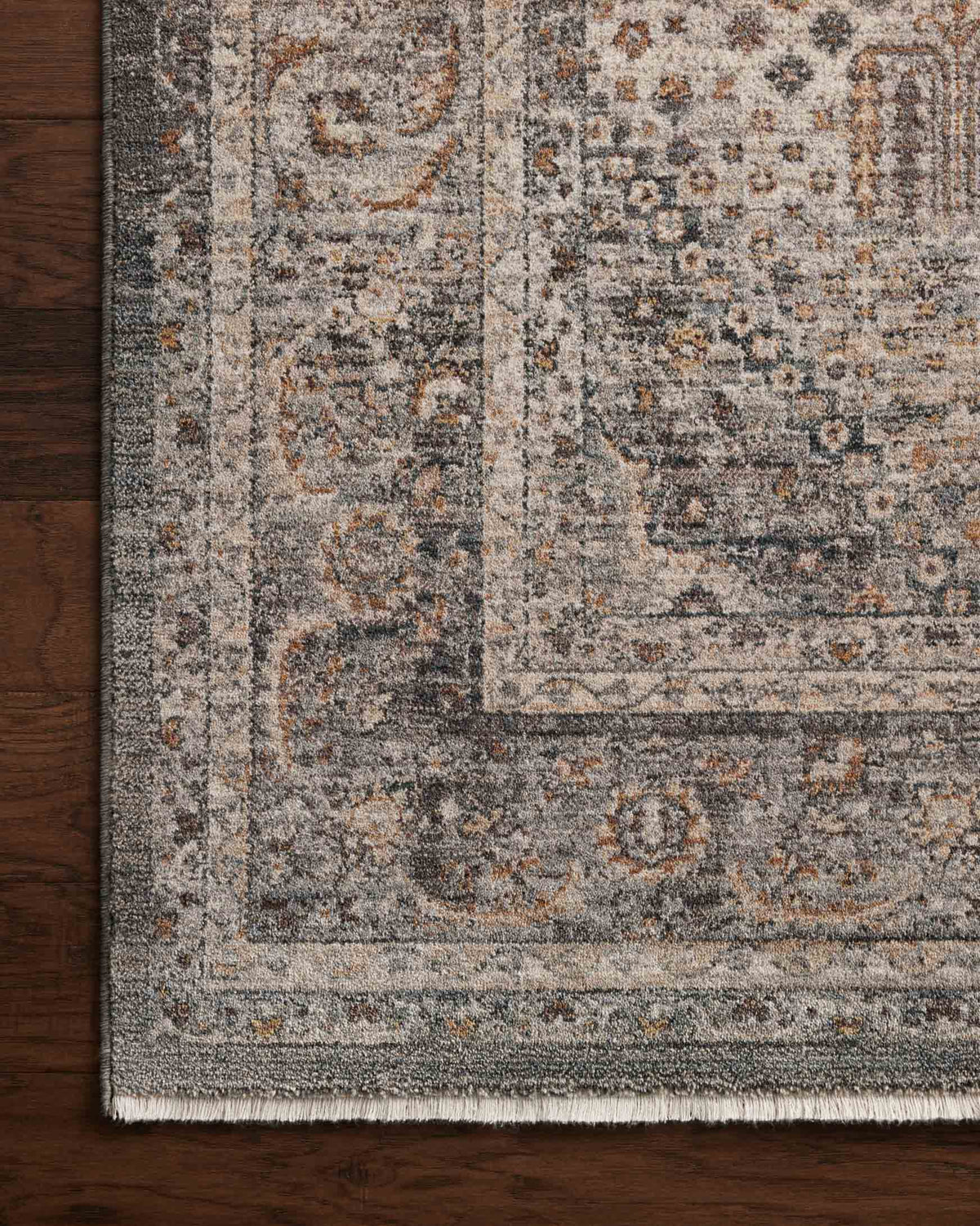 Close-up area rug with distressed textured pattern in gray, blue, and beige tones